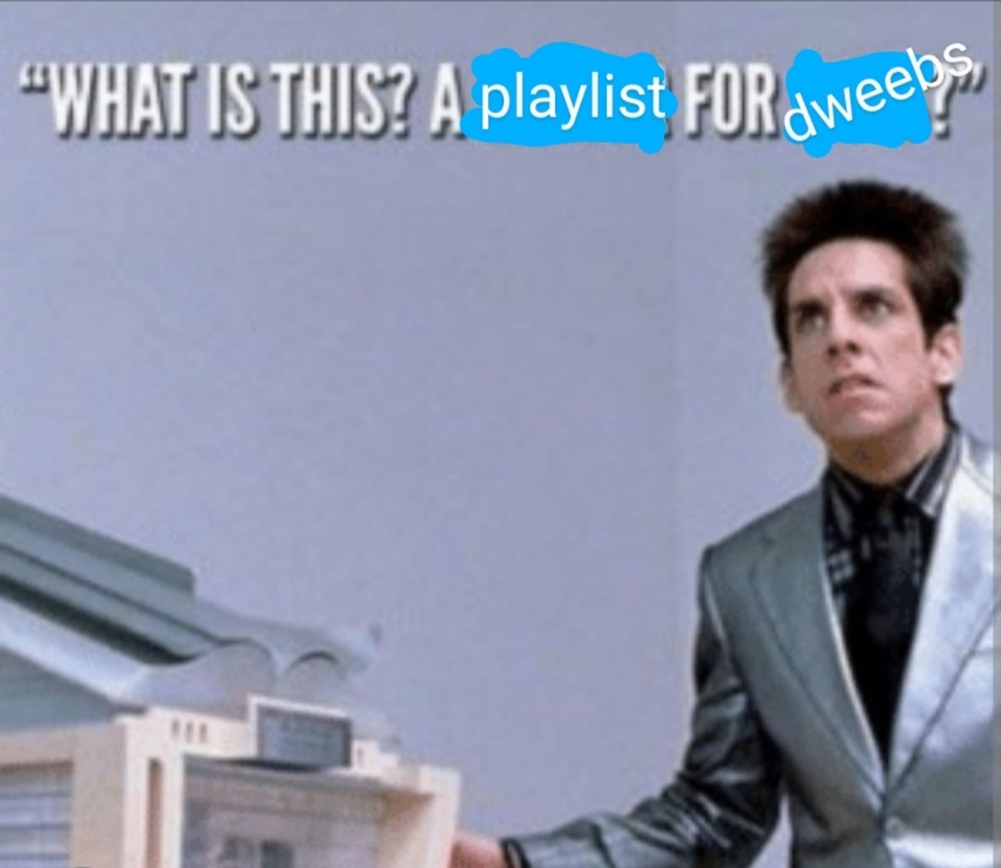 Zoolander, looking disgusted, stands in front of a scale model of the school he wants to build. Subtitles have been altered to read "What is this? A playlist for dweebs?"