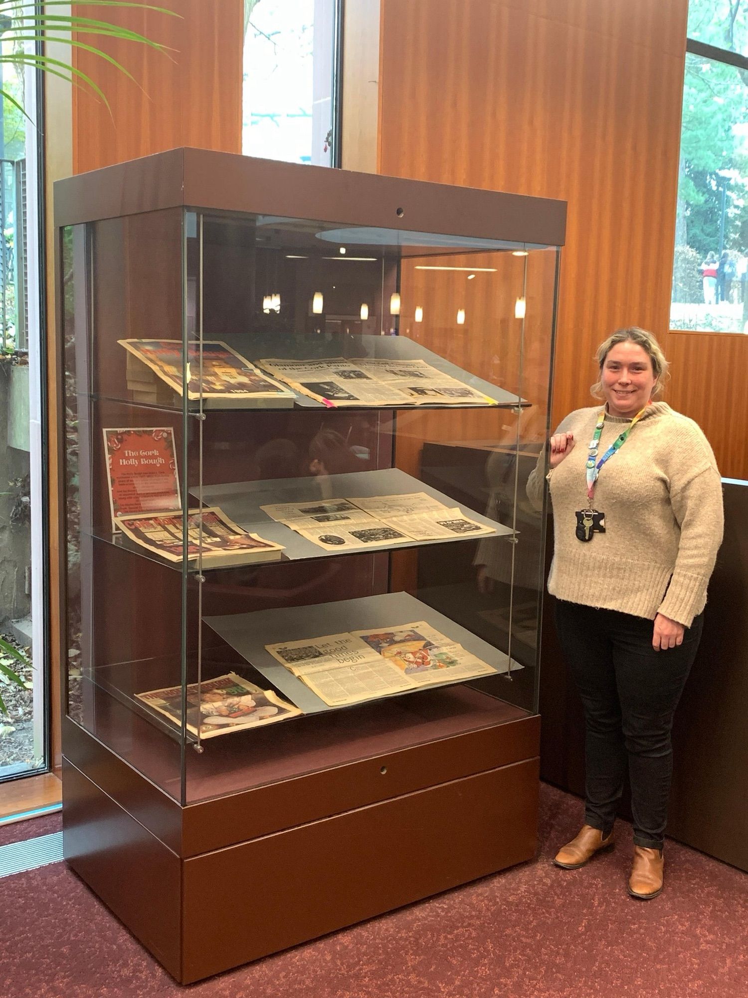 Person standing beside a display cabinet