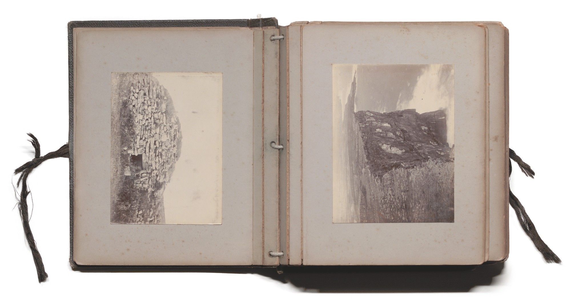 The collection comprises a bound 19th century album containing black and white photographic prints of the Aran Island Inis Mór, depicting landscapes, religious ruins, archaeological sites, domestic structures and their inhabitants.