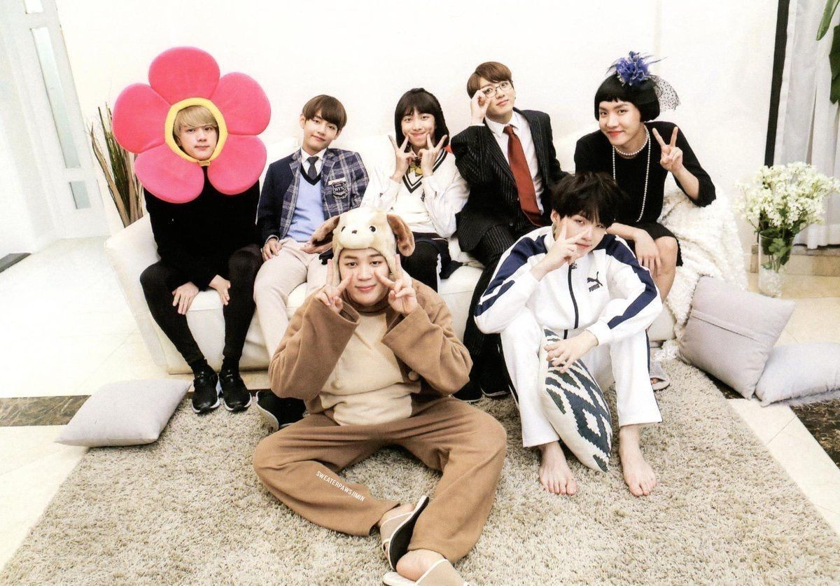 BTS dressed up in costumes: A flower, a puppy, a student, other grown up characters