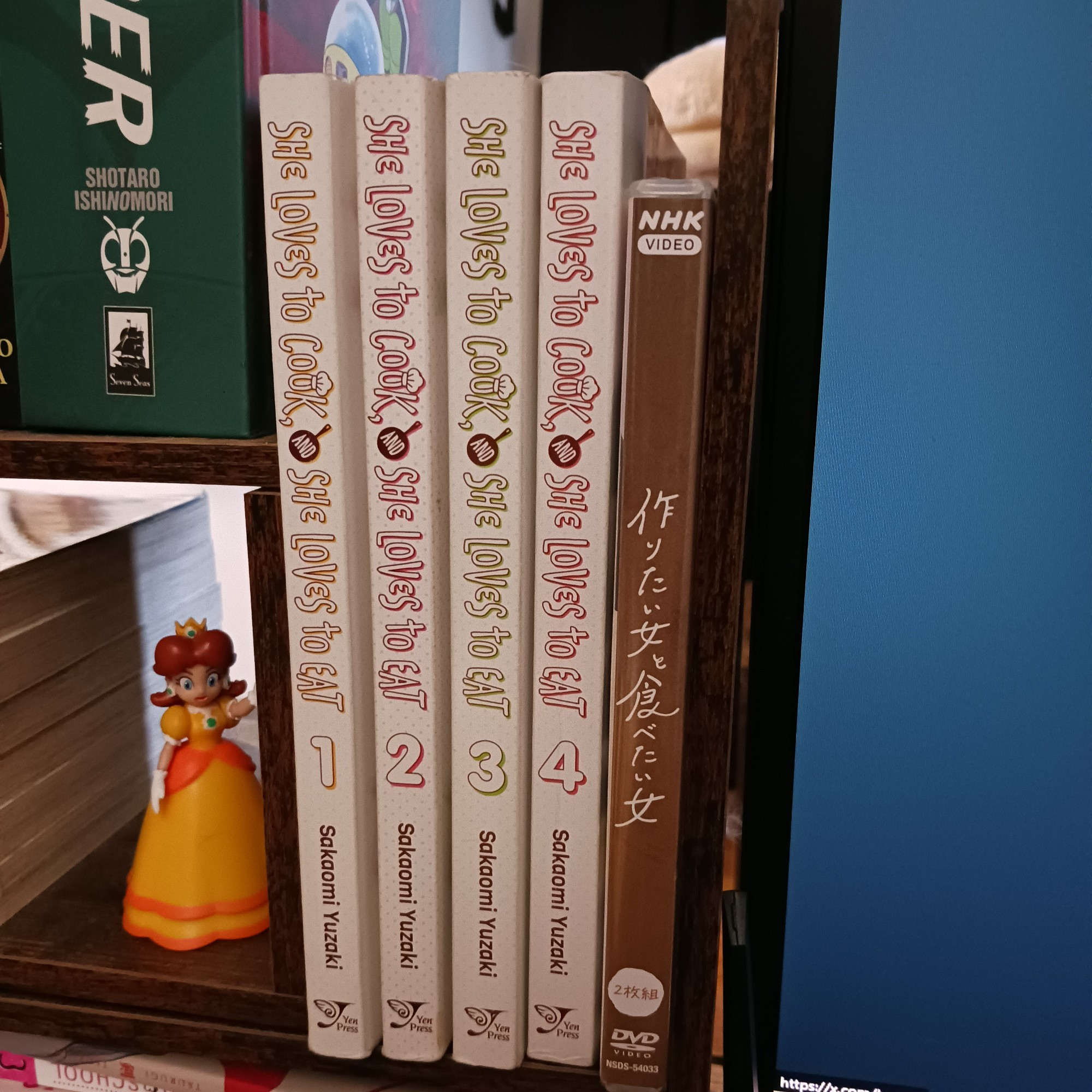 I have a little set of shelves that sit on my desktop at all times. They are all big inspirations, like the Rose of Versailles hardcovers, the Yen Press edition of the Azumanga Daioh omnibus and my Graphic-Sha "How to Draw Manga" books. But there's apart set aside JUST for Tsukutabe. The current collection (which is being shown off by a Princess Daisy figure) is all 4 of the currently-translated comics and the first season of the drama on DVD