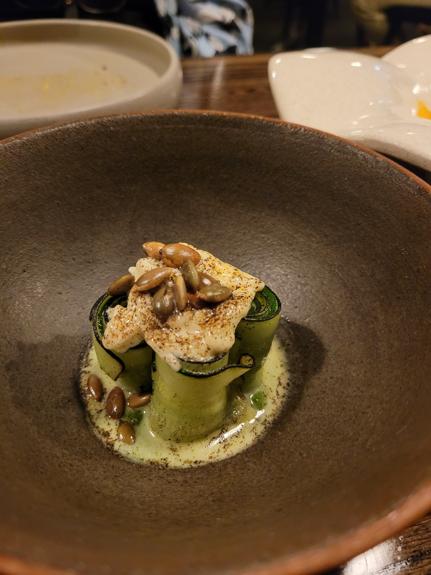 Charred courgettes, stracciatella, burnt onion ash, green chili puree