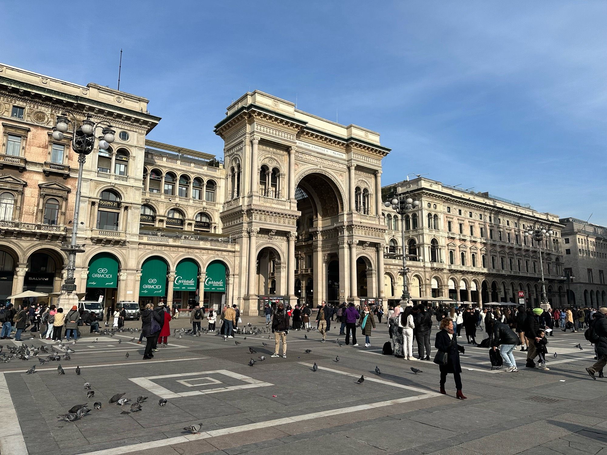 Big square, many birds, more people.