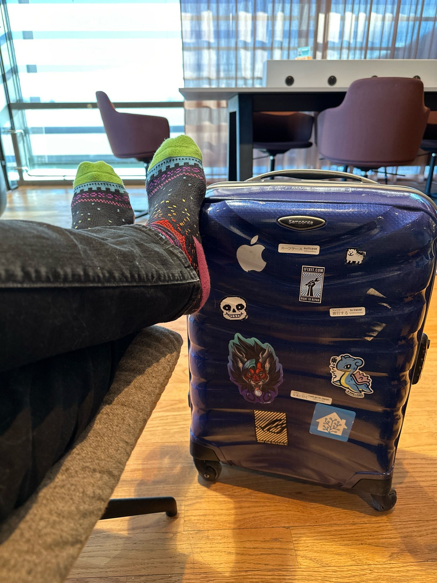 Colourful socks and my trusty blue travel companion enjoying the lounge together.