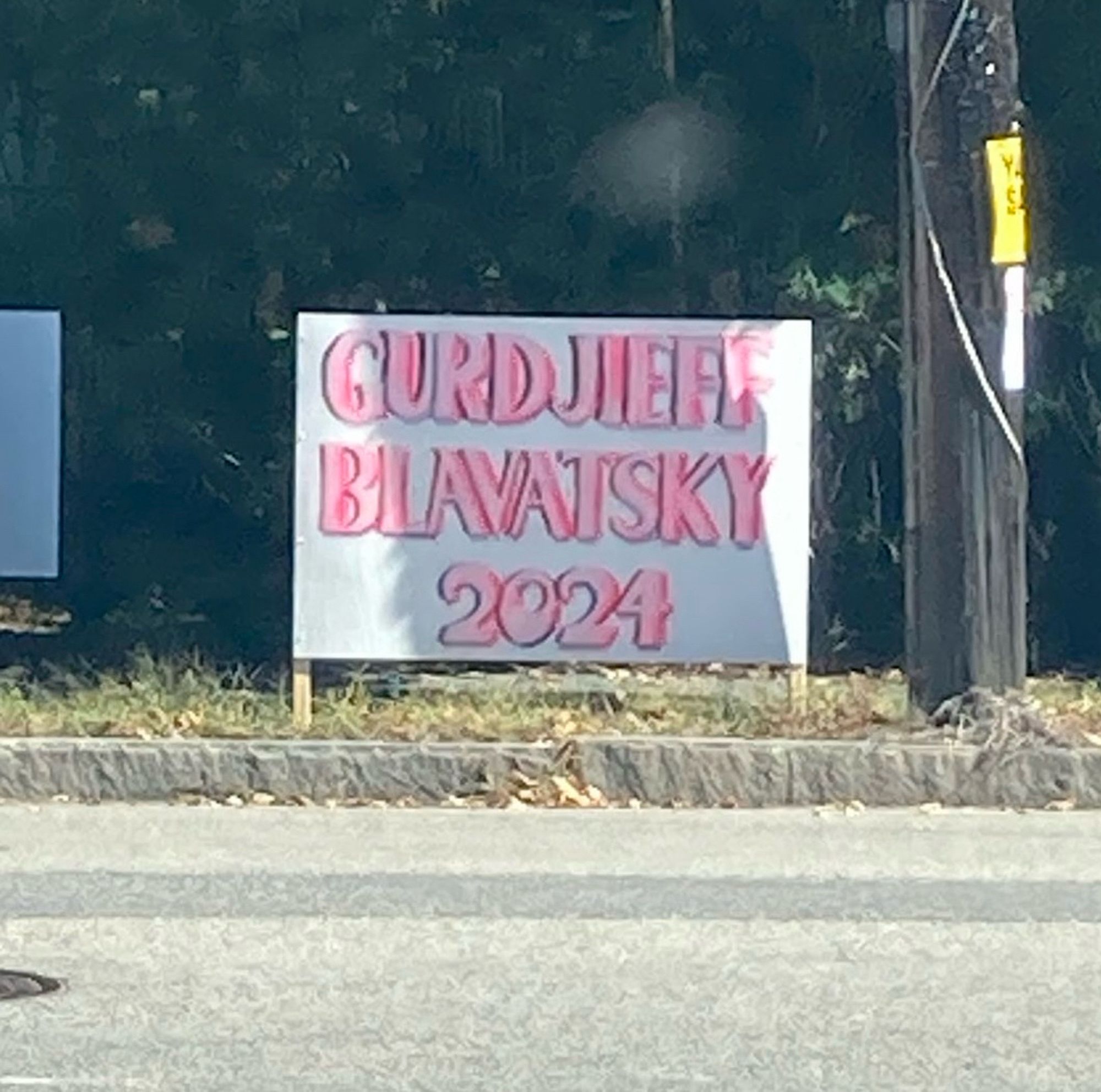 A hand drawn yard sign that says “Gurdjieff Blavatsky 2024”