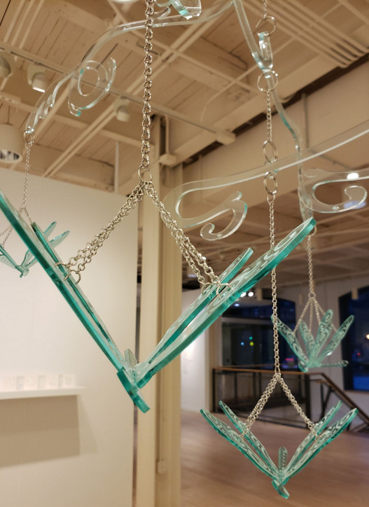 A hanging sculpture that includes laser-cut acrylic dragonflies. 