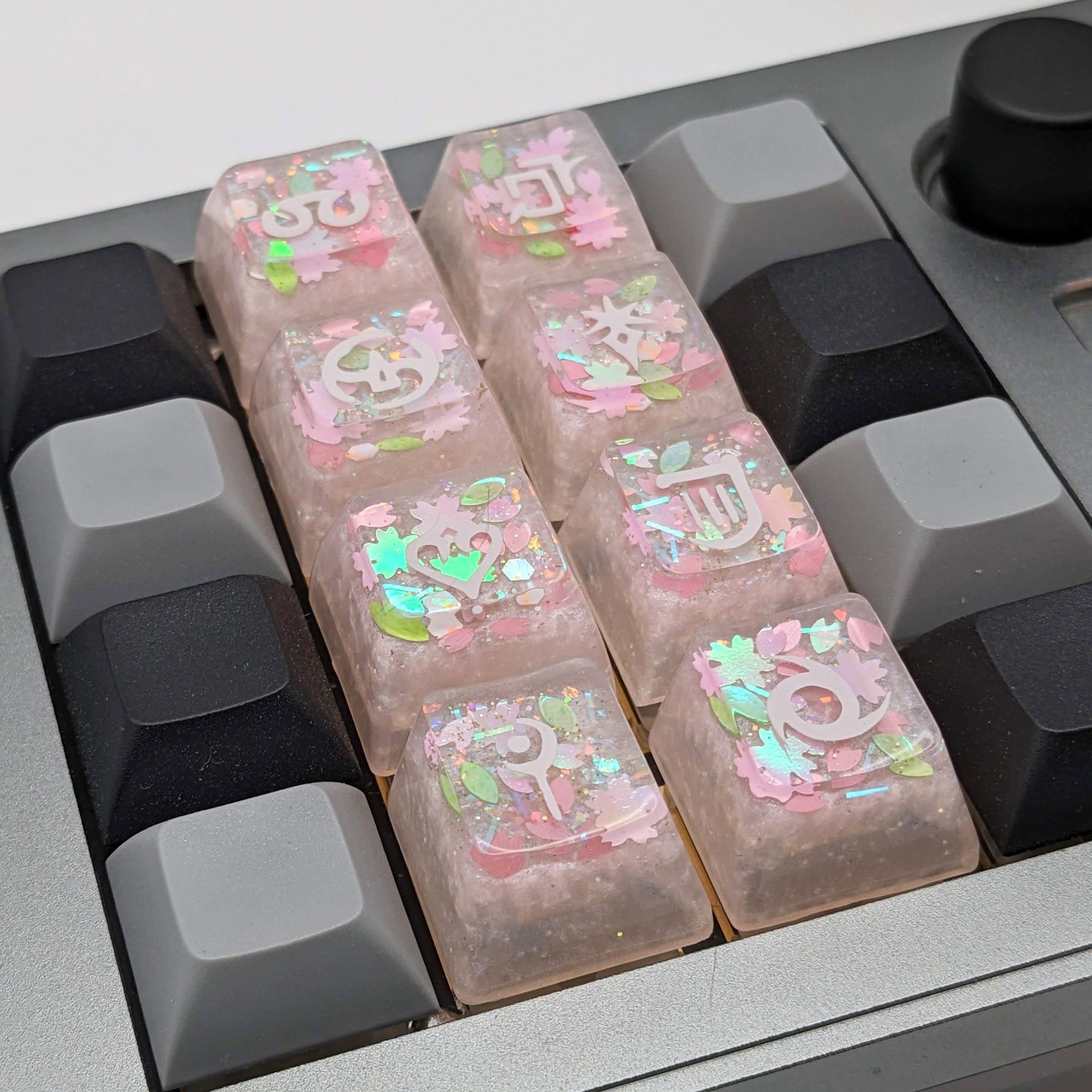 A picture of handmade FFXIV sakura themed job icon keycaps