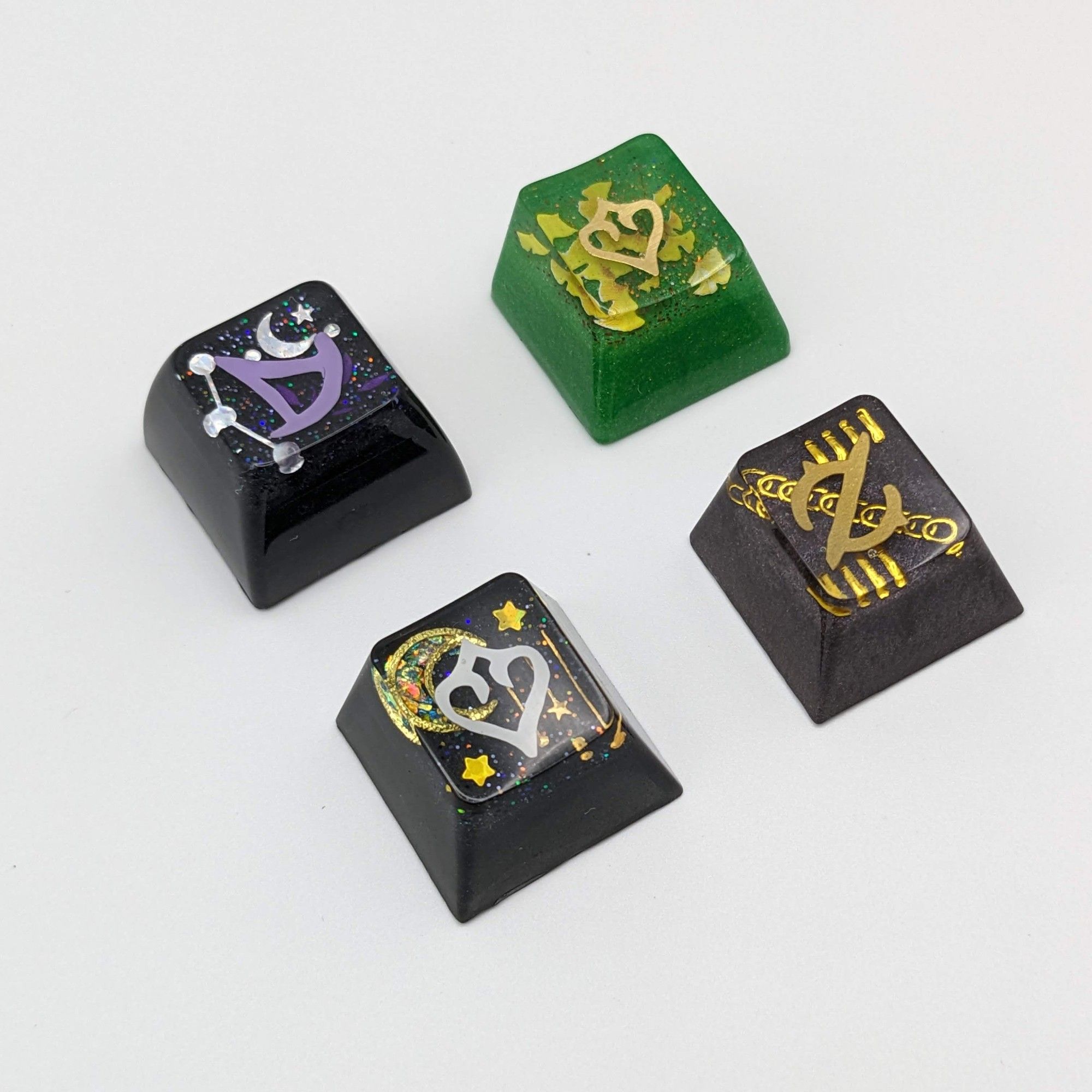 A picture of 4 handmade FFXIV job icon keycaps