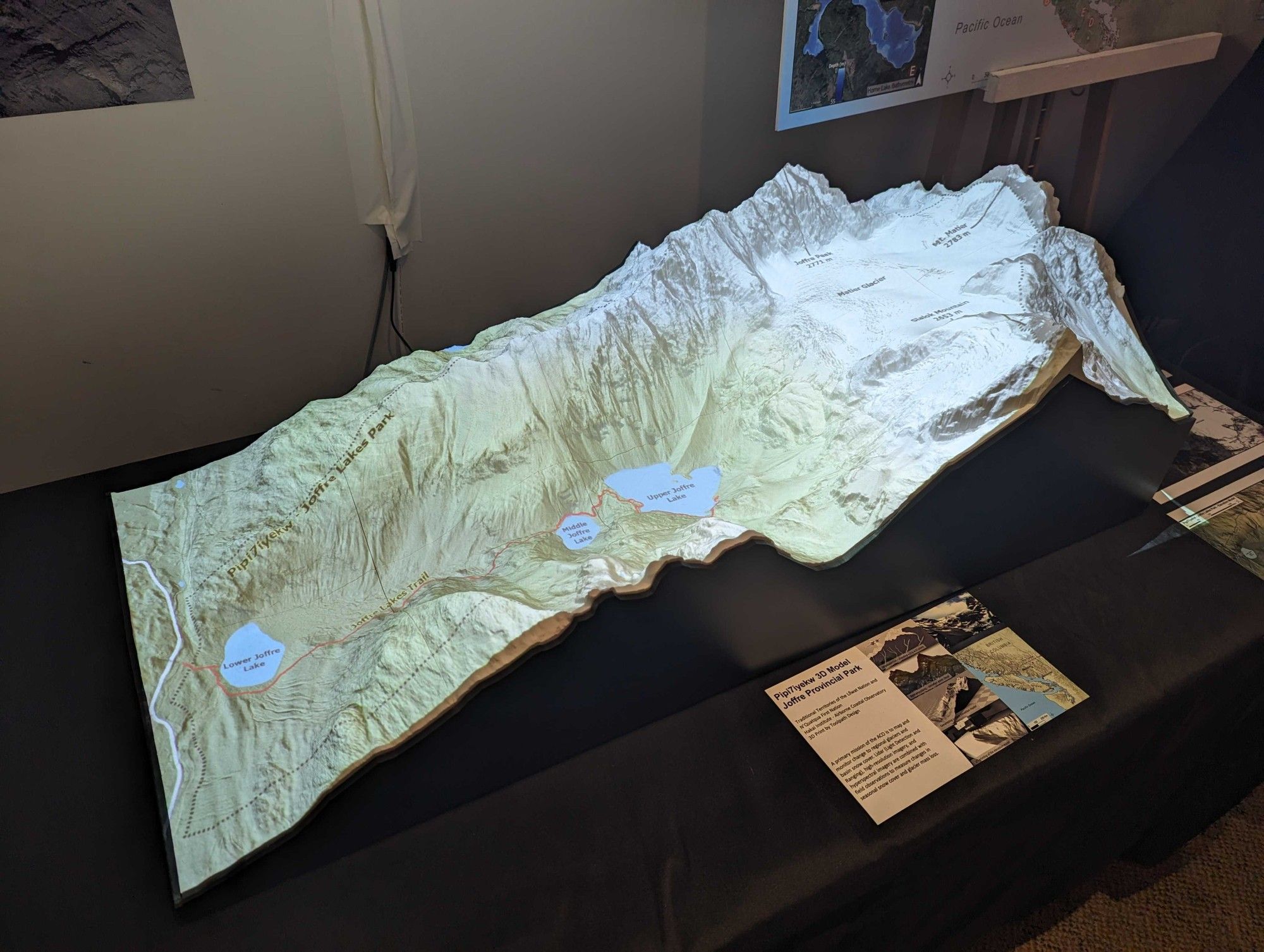 A 3D terrain model of Pipi7iyekw Joffre Provincial Park with landscape features projected onto it, sitting on a black table.