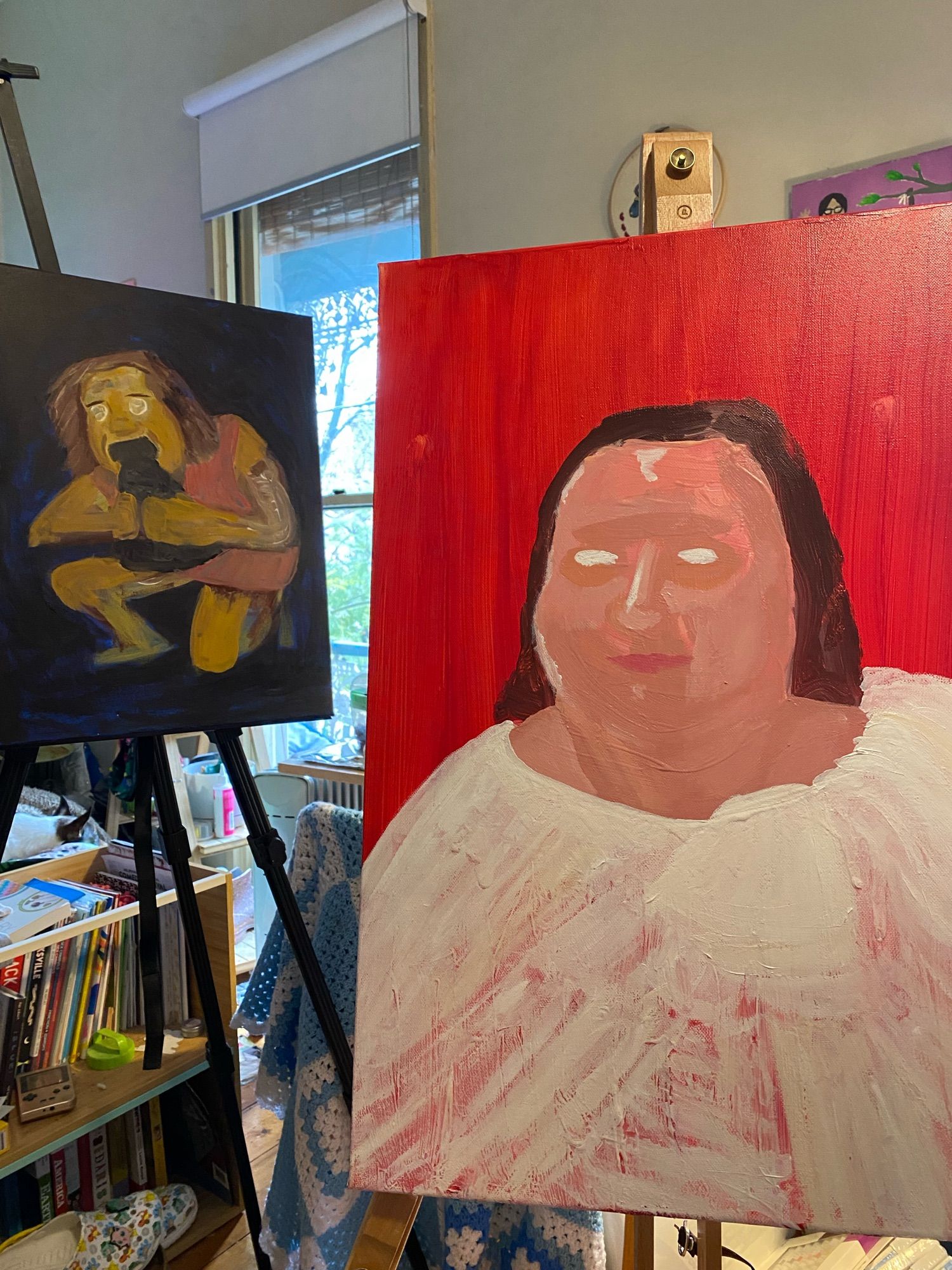 Two partially completed paintings of Gina Rinehart. On the left, a small cool-toned painting, depicting Gina in the style of Saturn Devouring His Son. On the right, a warm-toned painting of Gina, where I’ve painted some facial features, but the eyes are just white blobs at the moment.