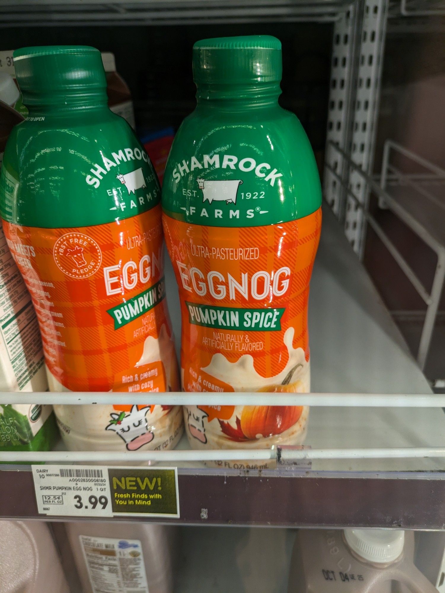 Bottles of pumpkin spice eggnog on a grocery store shelf