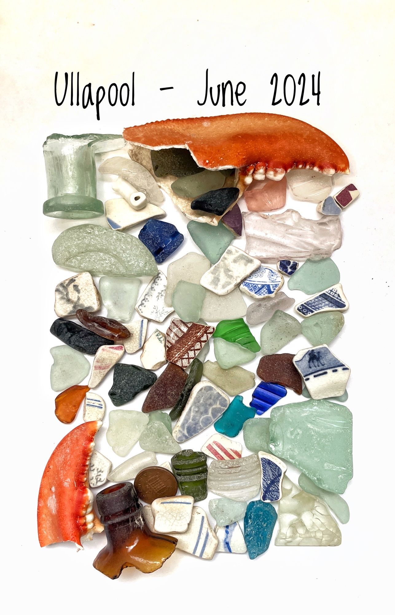 A flat lay of misc beachcombing finds, including two large orange lobster claws, seaglass in multiple colours and shapes , beach pottery with patterns and stripes. Text above reads “ullapool June 2024”