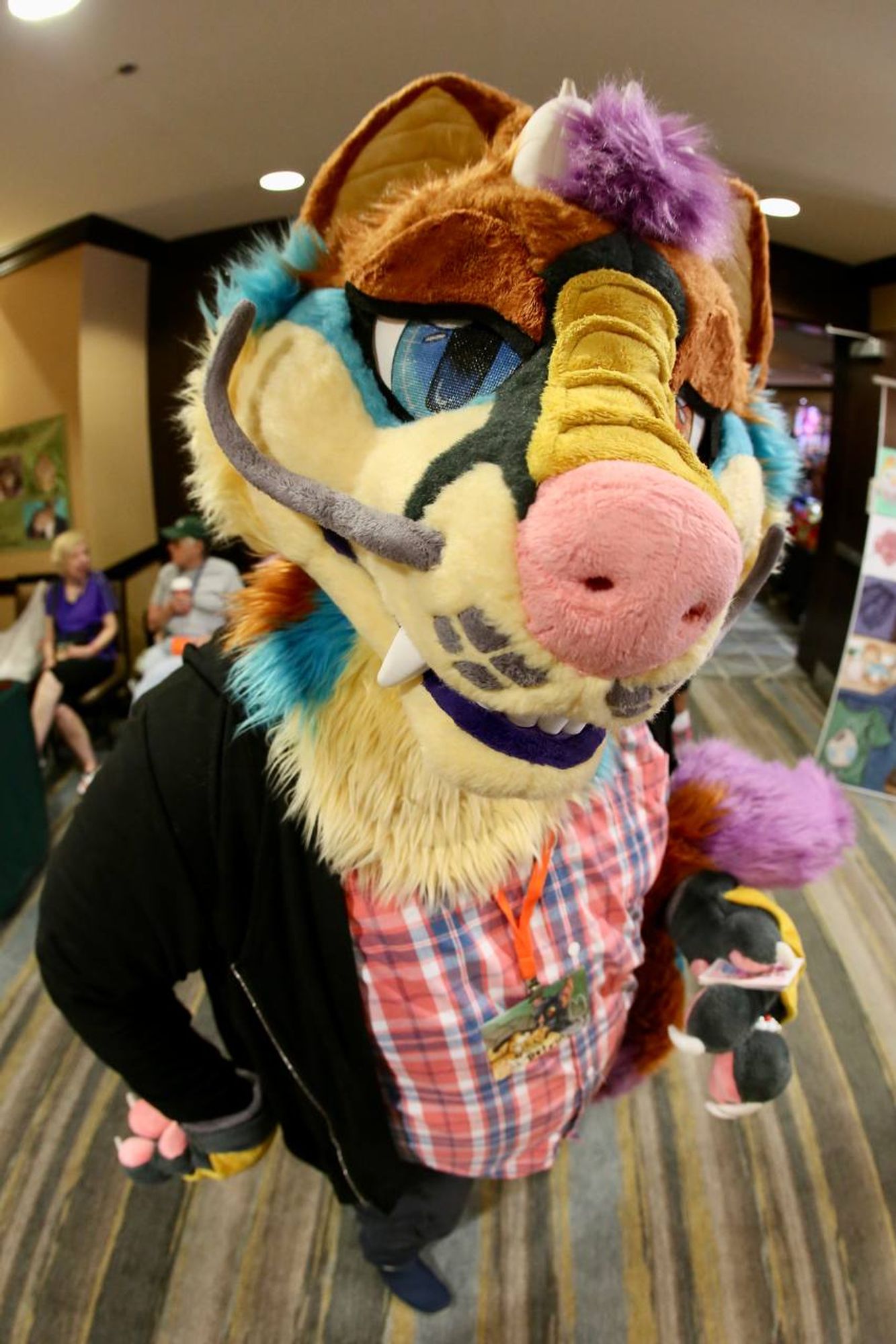 A fursuiter is posing turned to face the camera and is close to the lense causing perspective distortion. One eye appears bigger as if observing you. Where the perspective looking down shows a tiny foot making the fursuiter appear to tower up to the lense.