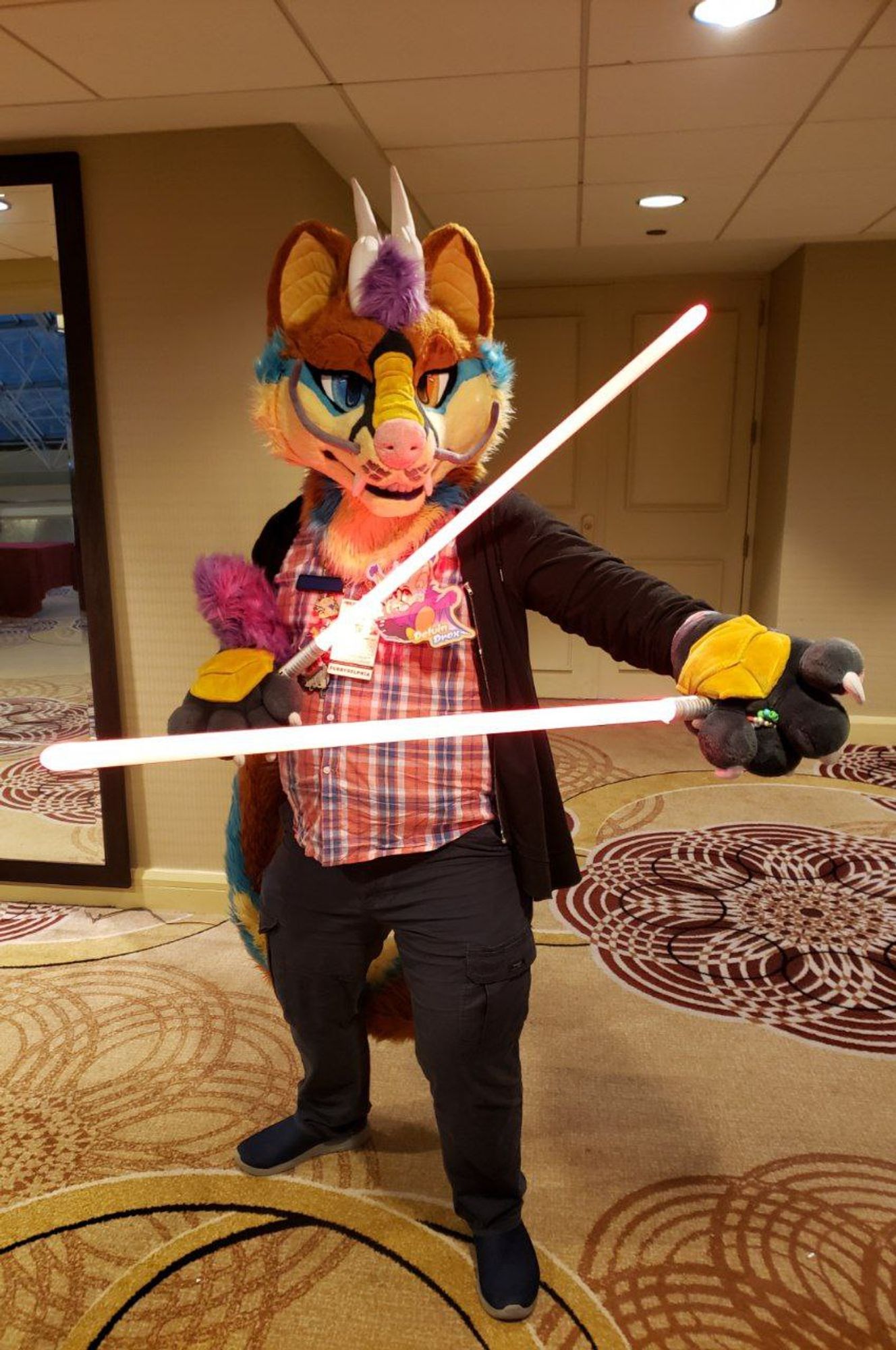 Fursuiter standing holding a pair of light red sabers crisscrossed in a pensive stance.