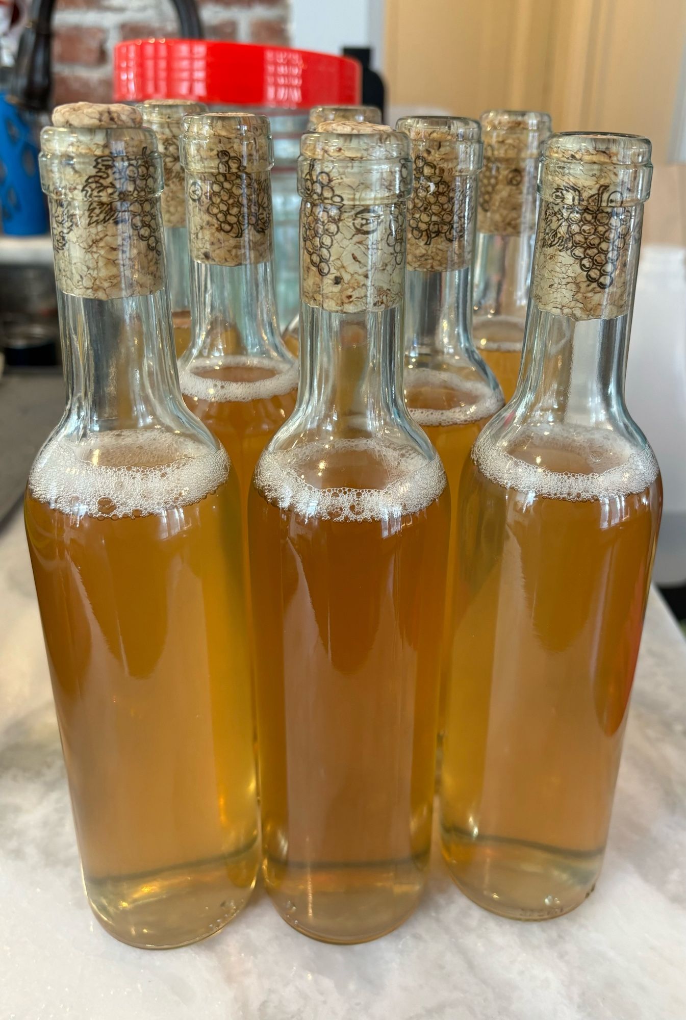 Eight 385ml bottles of slightly hazy golden mead