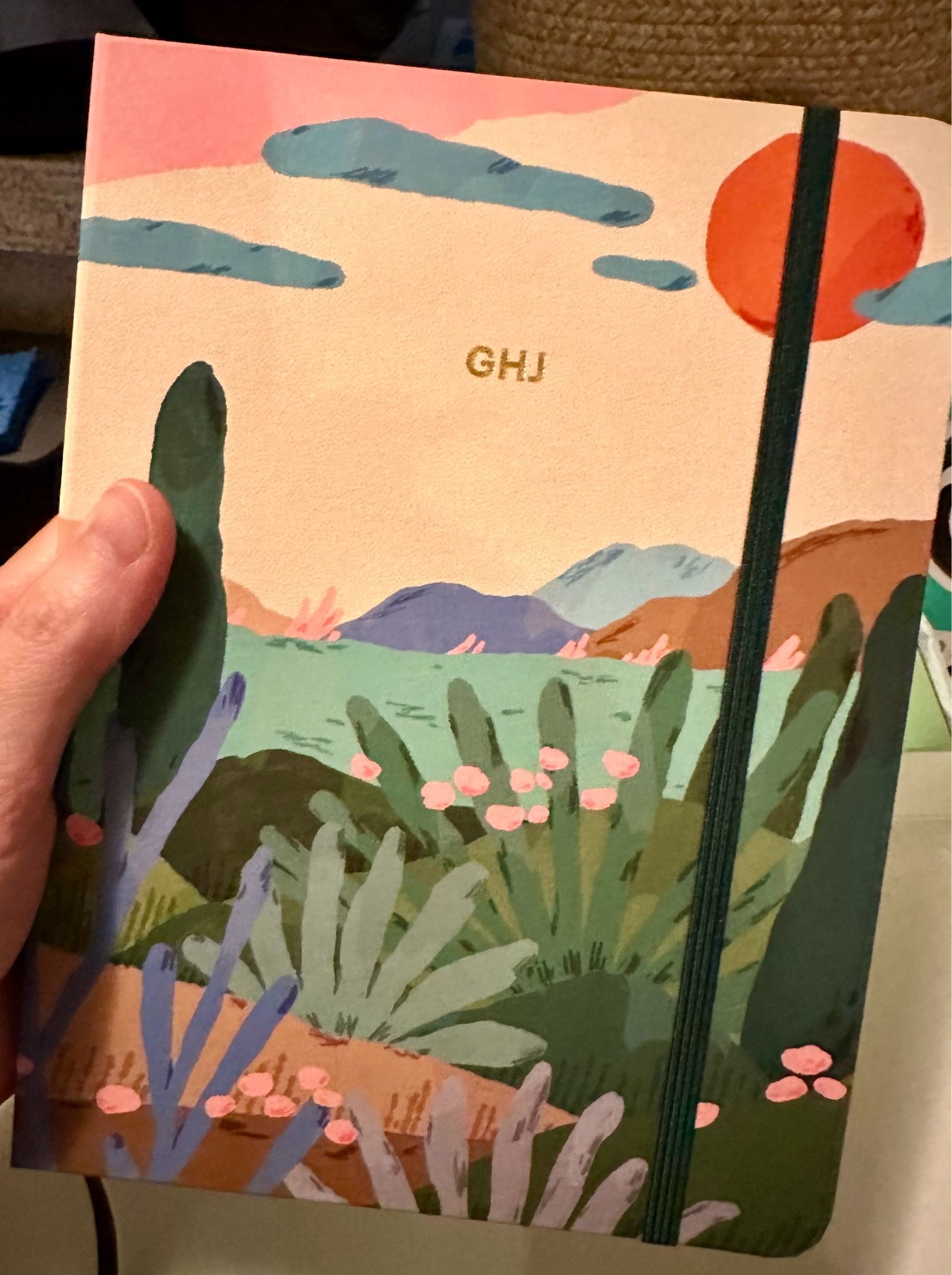 Yearly planner from Mossery. The cover depicts a painted landscape full of desert plants.