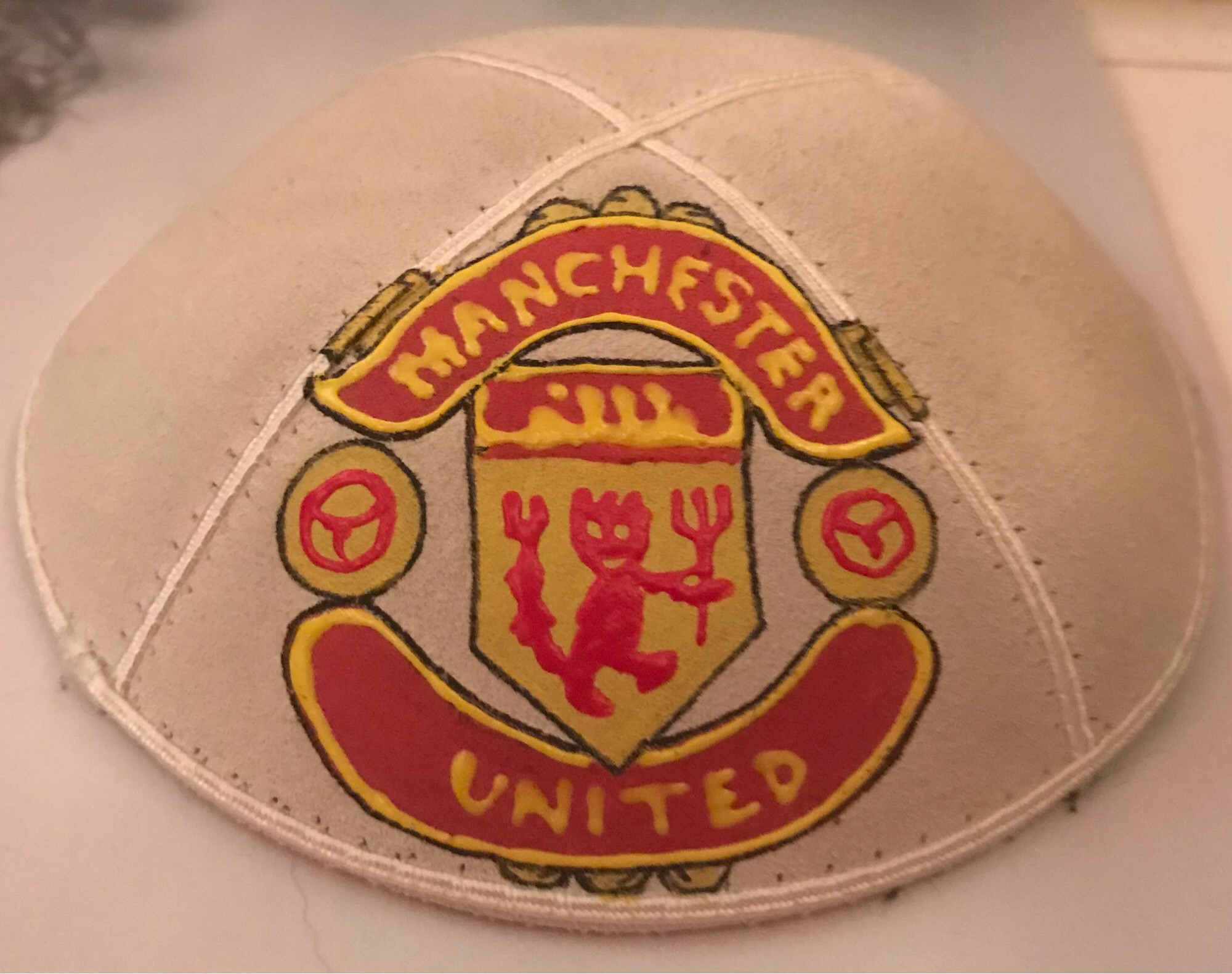 White kippah with hand painted Manchester United logo.