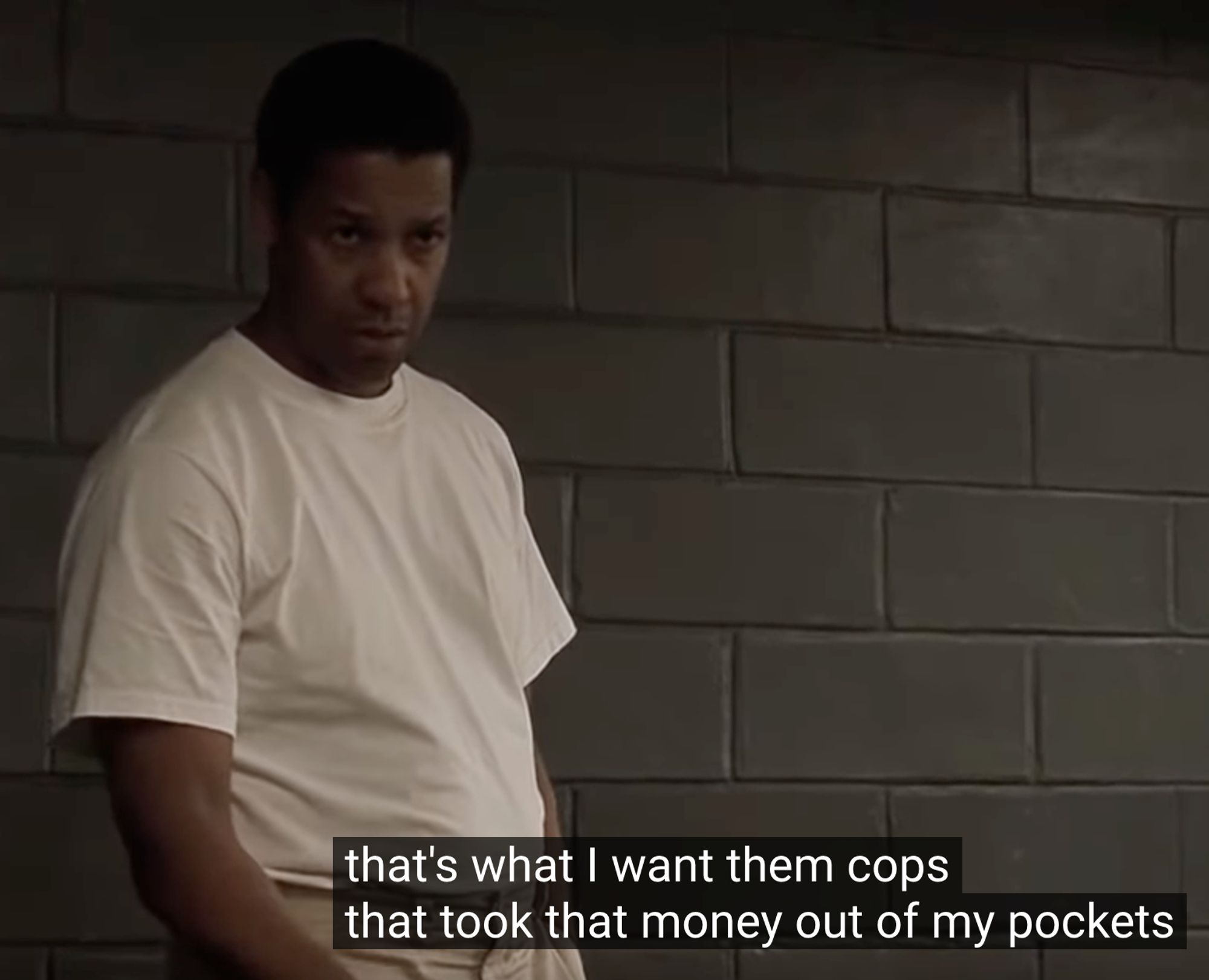 Still from the film American Gangster.  Frank Lucas (played by Denzel Washington), is in a police interview room negotiating his plea.  The caption says "I want them cops that took that money out of my pockets."