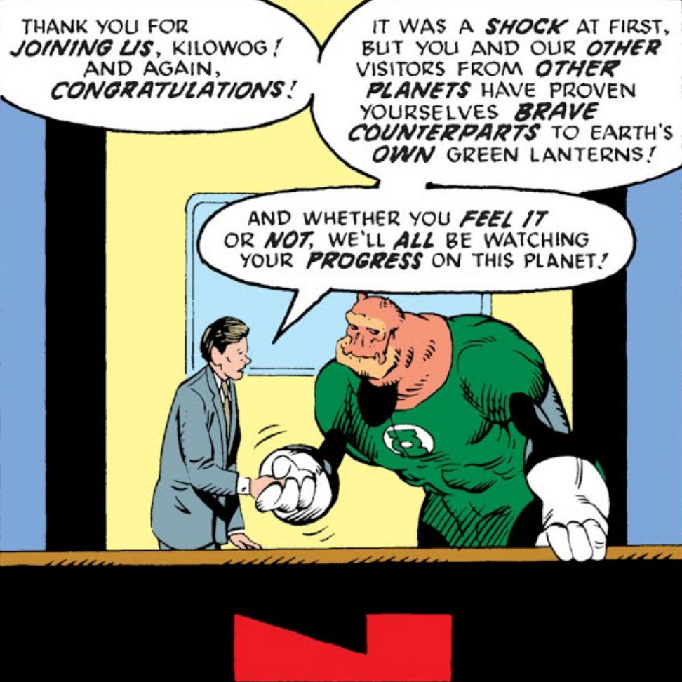 In a comic panel Kilowog, in Green Lantern uniform, shakes hands with a comic book version of news anchor Tom Brokaw behind a news desk. Tom says, "Thank you for joining us, Kilowog! And again, congratulations! It was a shock at first, but you and our other visitors from other planets have proven yourselves brave counterparts to Earth's own Green Lanterns! And whether you feel it or not, we'll all be watching your progress on this planet!"