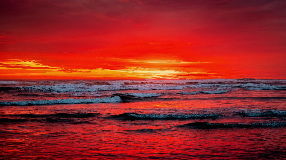 A dramatic red sunset over the Pacific Ocean.

The sky is red--bright, intense red--and stretches side to side. The setting sun provides a rich, deep orange streak from the center going to the left, just above the ocean.

The ocean itself reflects the deep reds and gentle waves are rolling in.

There's nothing except the red sky, the red water and gentle rolling waves.