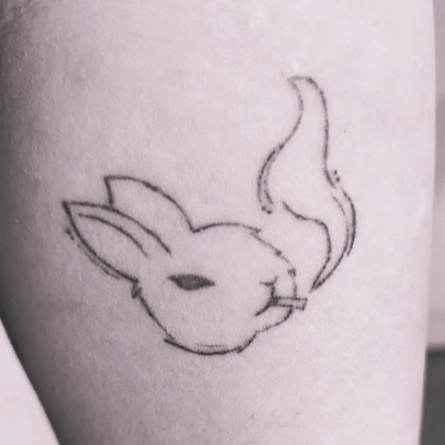 Tattoo of white rabbit without spike collar smoking a cigarette 