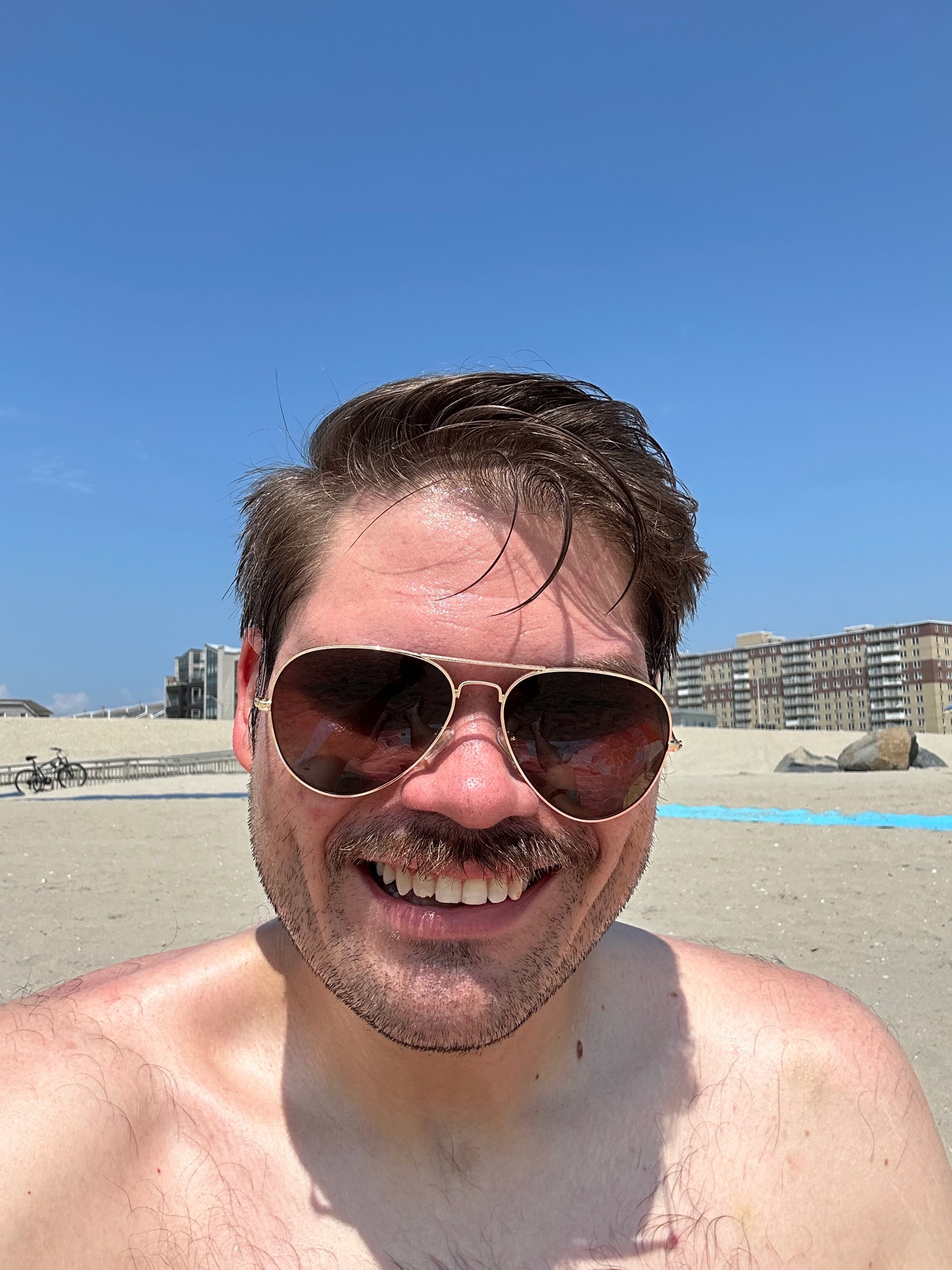 Drunk man in sunglasses on Rockaway Beach, NYC