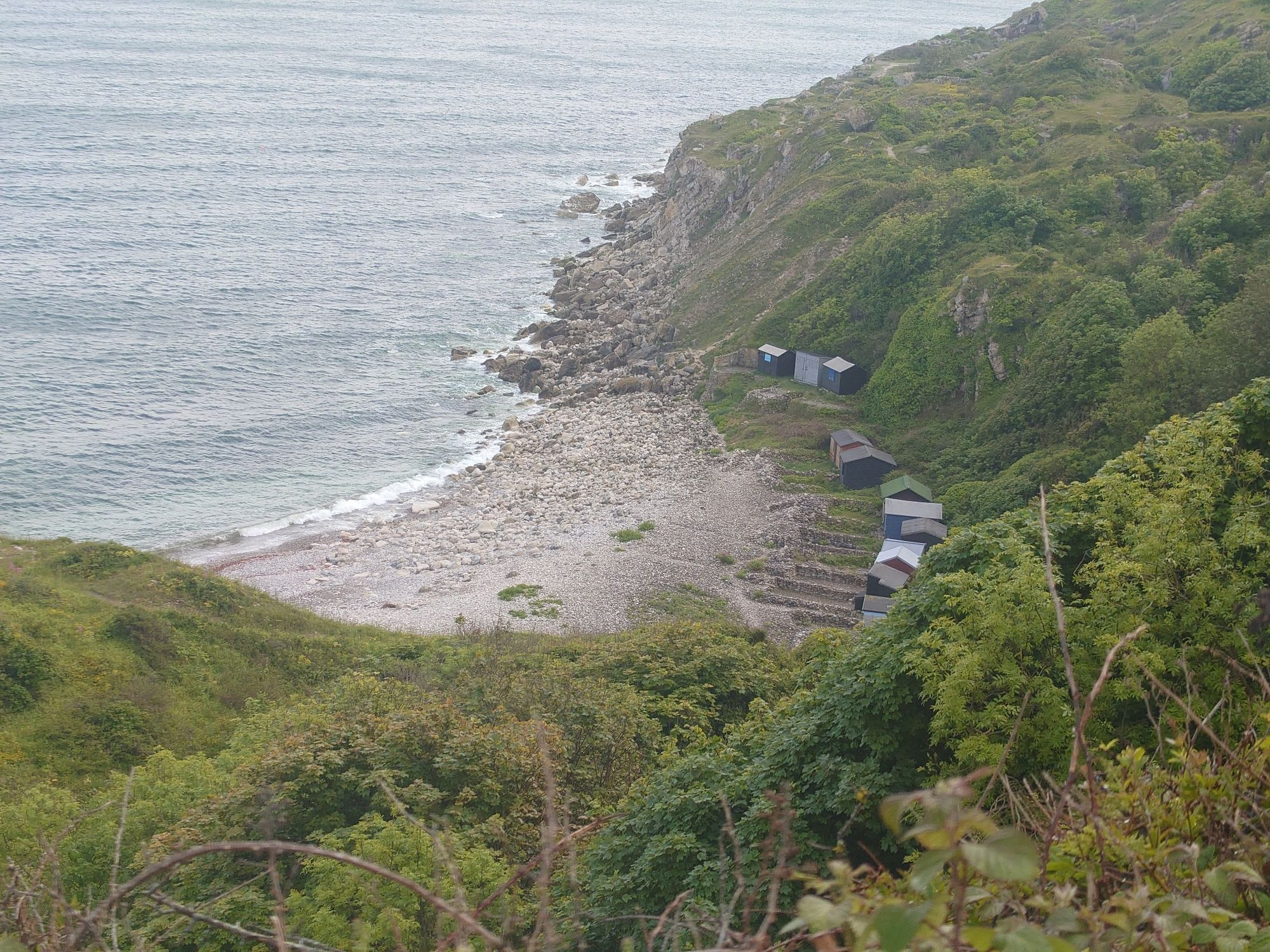 General view of the cove showing stony beach