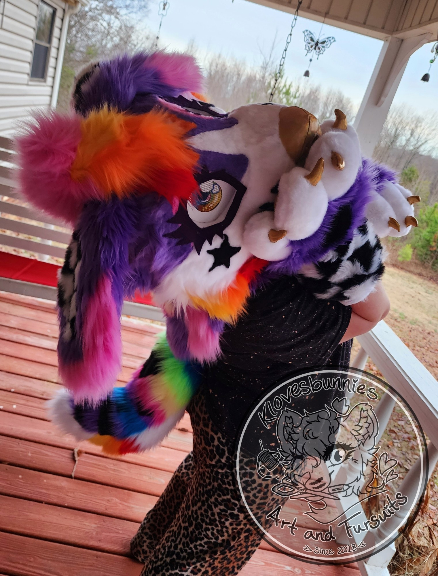 Jett the sparkledog fursuit, purple and white with checked ears and rainbow markings. 

#furryart #fursuitforsale #fursuit #fursuitfriday #cutefursuit