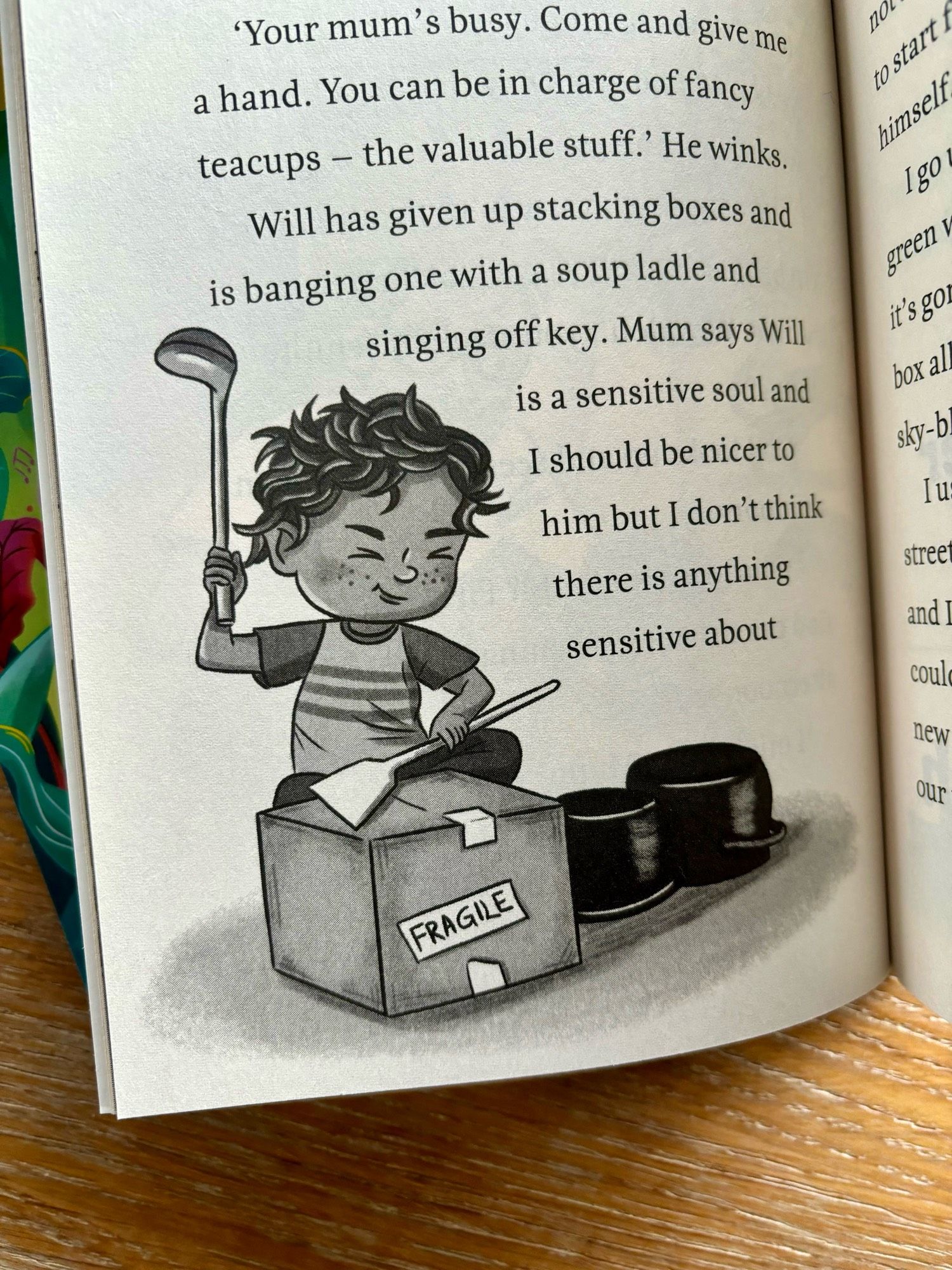 Inside the pages of Ella and the Amazing Frog Orchestra, a new middle grade fiction book. A black and white illustration of the main character’s younger brother, pretending to play the drums on a cardboard box and pots.