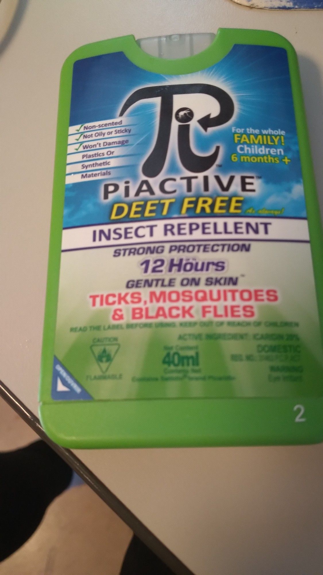 Small flat green plastic container of Piactive deet free insect repellent