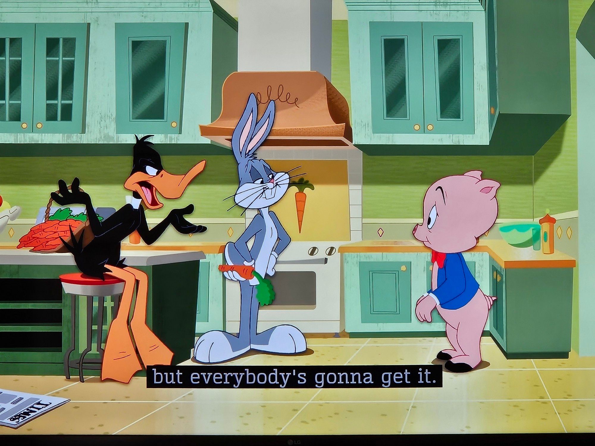 Daffy talking to Porky in the kitchen while Bugs looks on: "... but everybody's gonna get it."