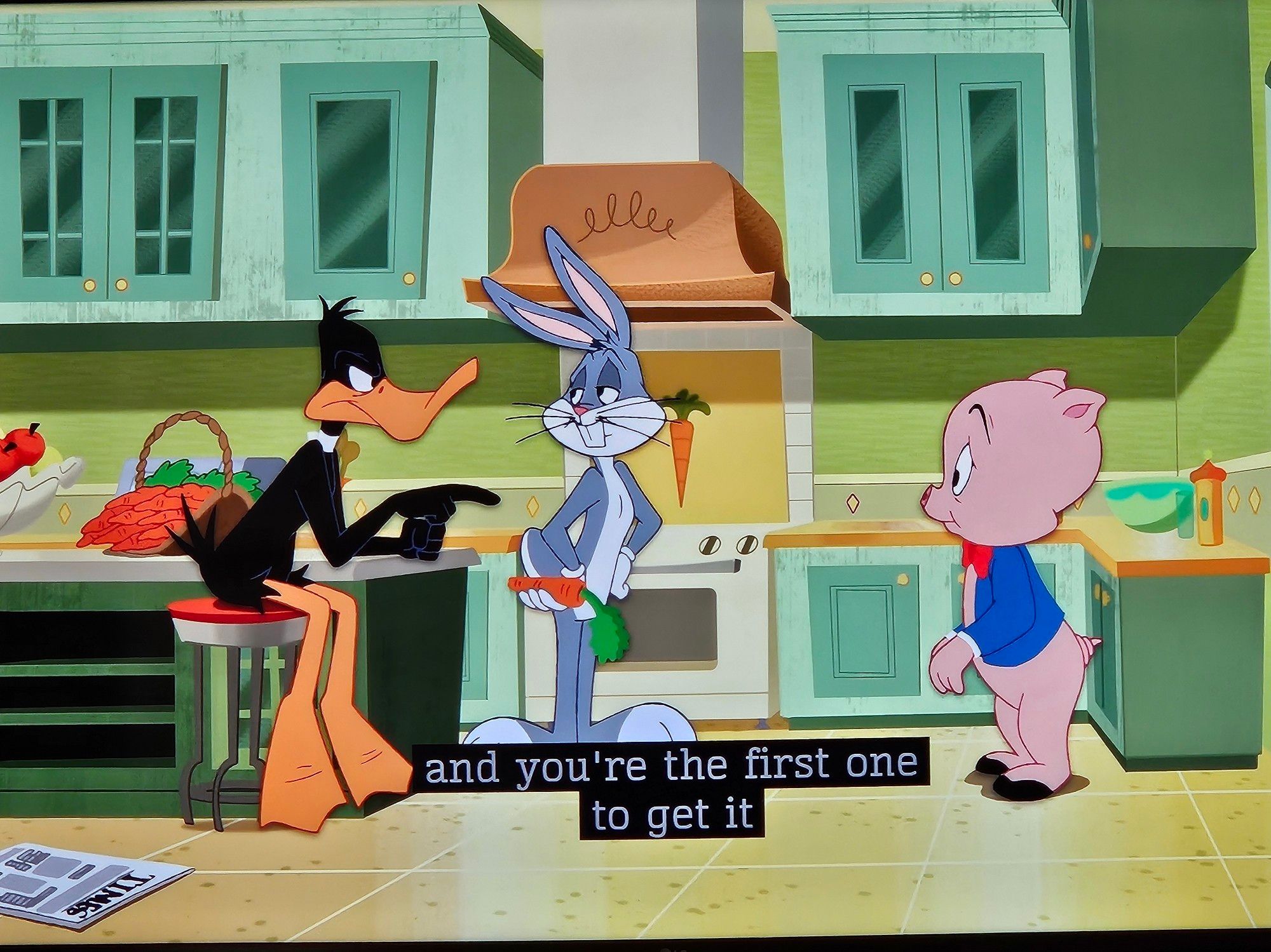 Daffy talking to Porky in the kitchen while Bugs looks on: "...and you're the first one to get it..."