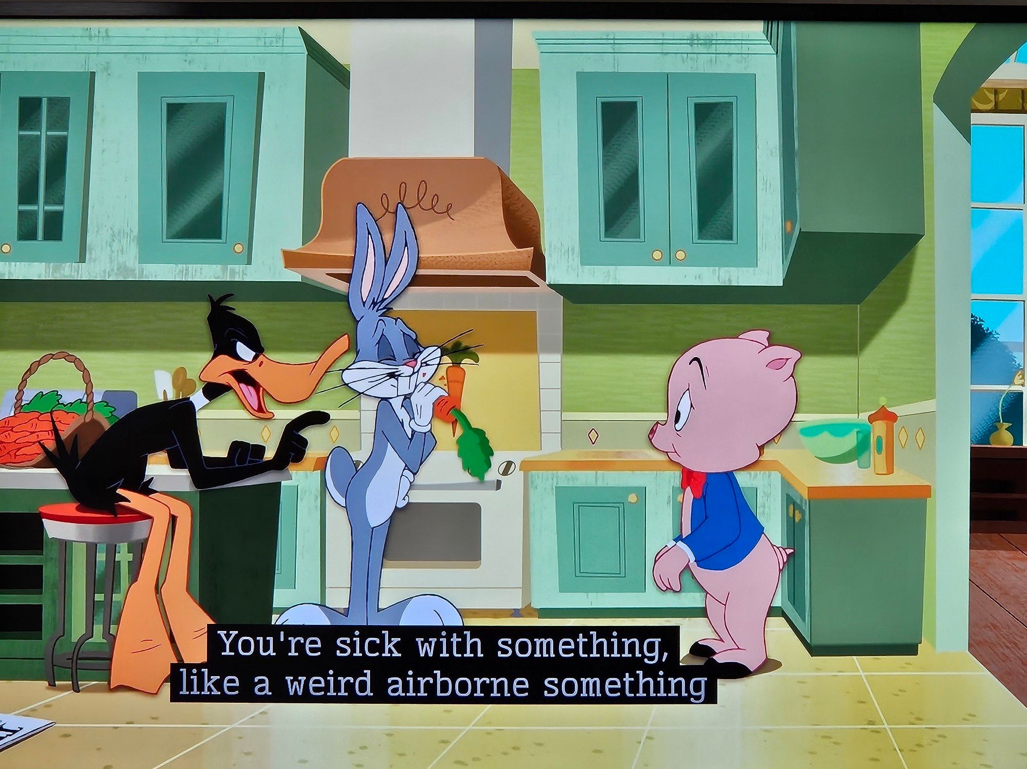 Daffy talking to Porky in the kitchen while Bugs looks on: "You're sick with something, like a weird airborne something..."