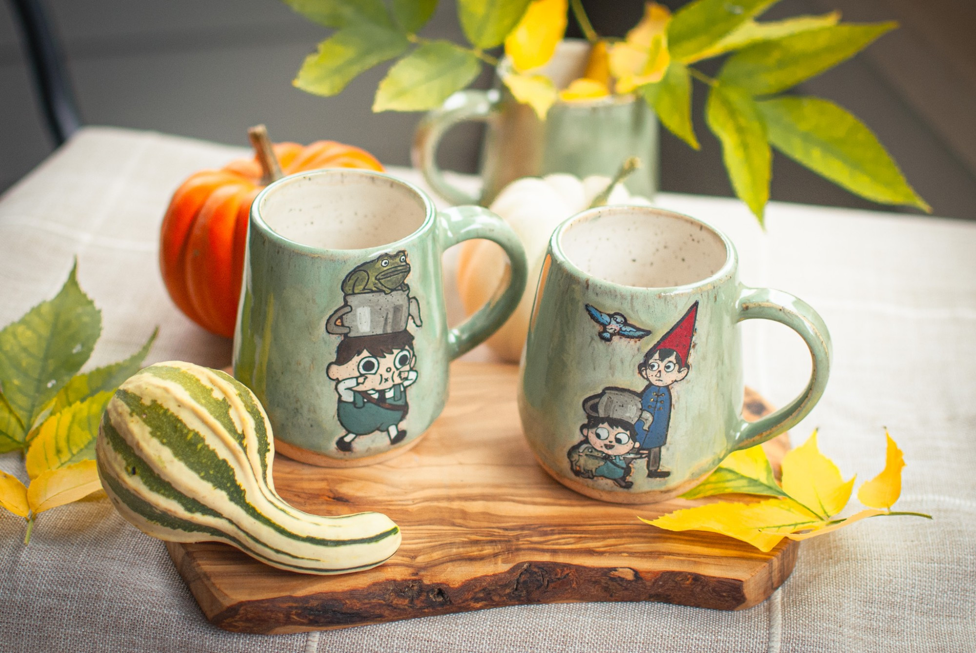 Ceramic mugs with Greg and Wirt from over the garden wall painted on them.