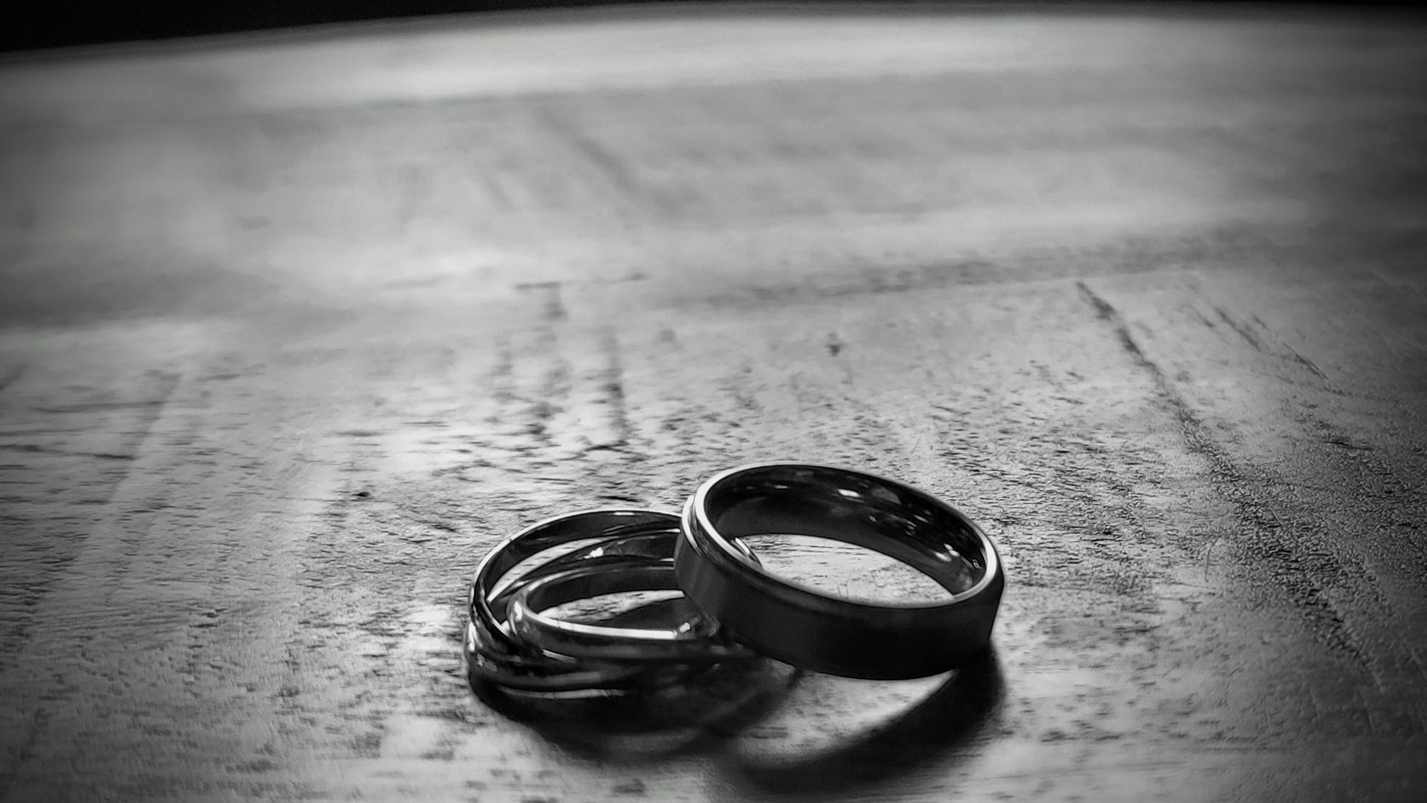 My engagement and wedding rings on a java wood table, used for one of my short stories.