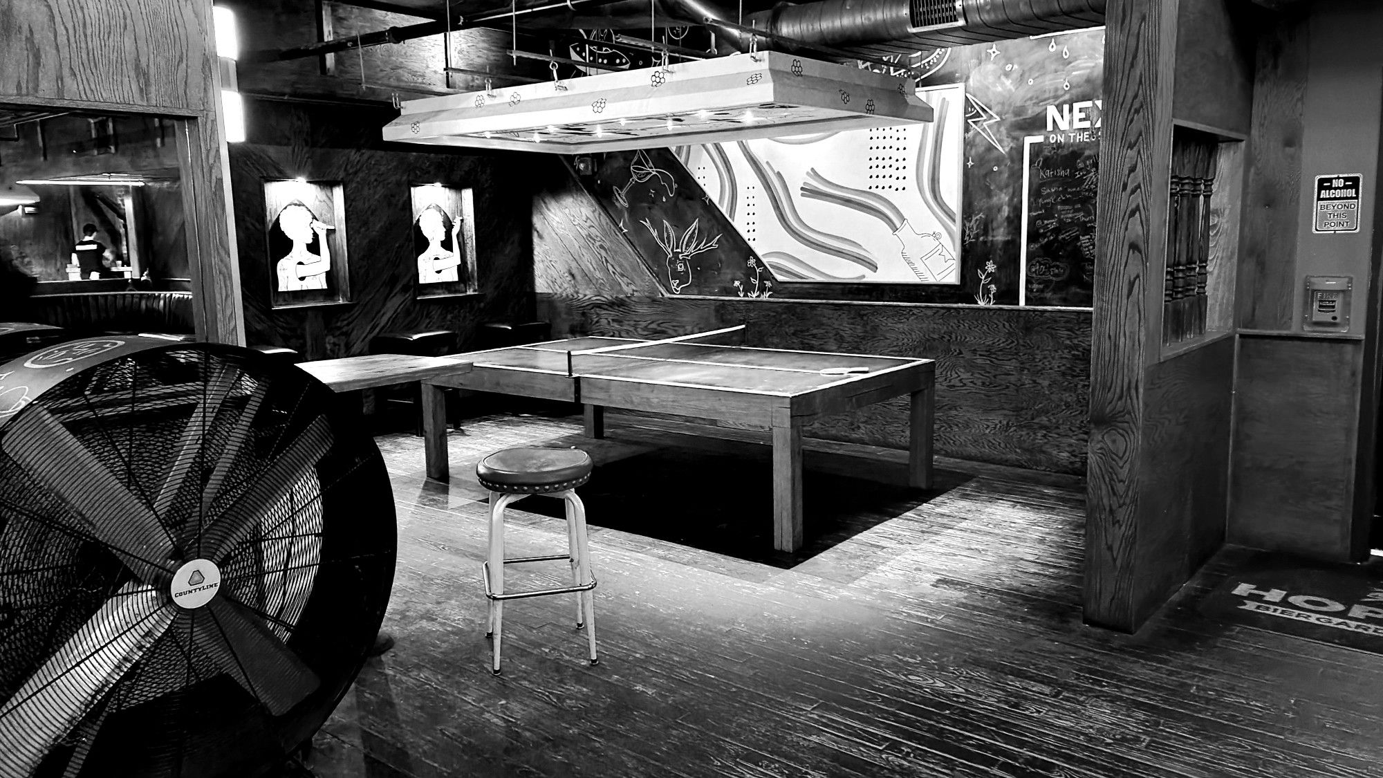 A ping-pong table at an empty bar just before opening. Taken at Hoptinger Beirgarten in Jacksonville, Florida, in April of 2023.