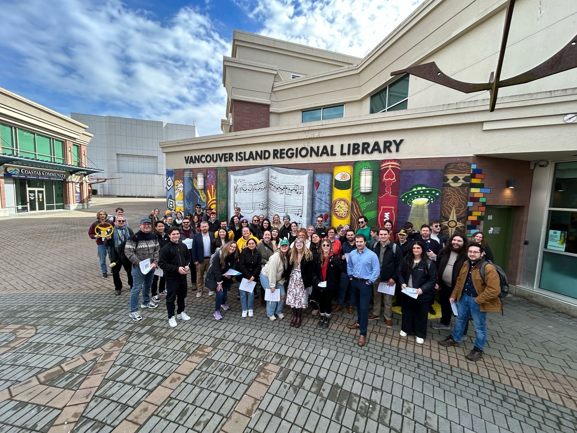 Education students on a field trip pose in front of their local library.