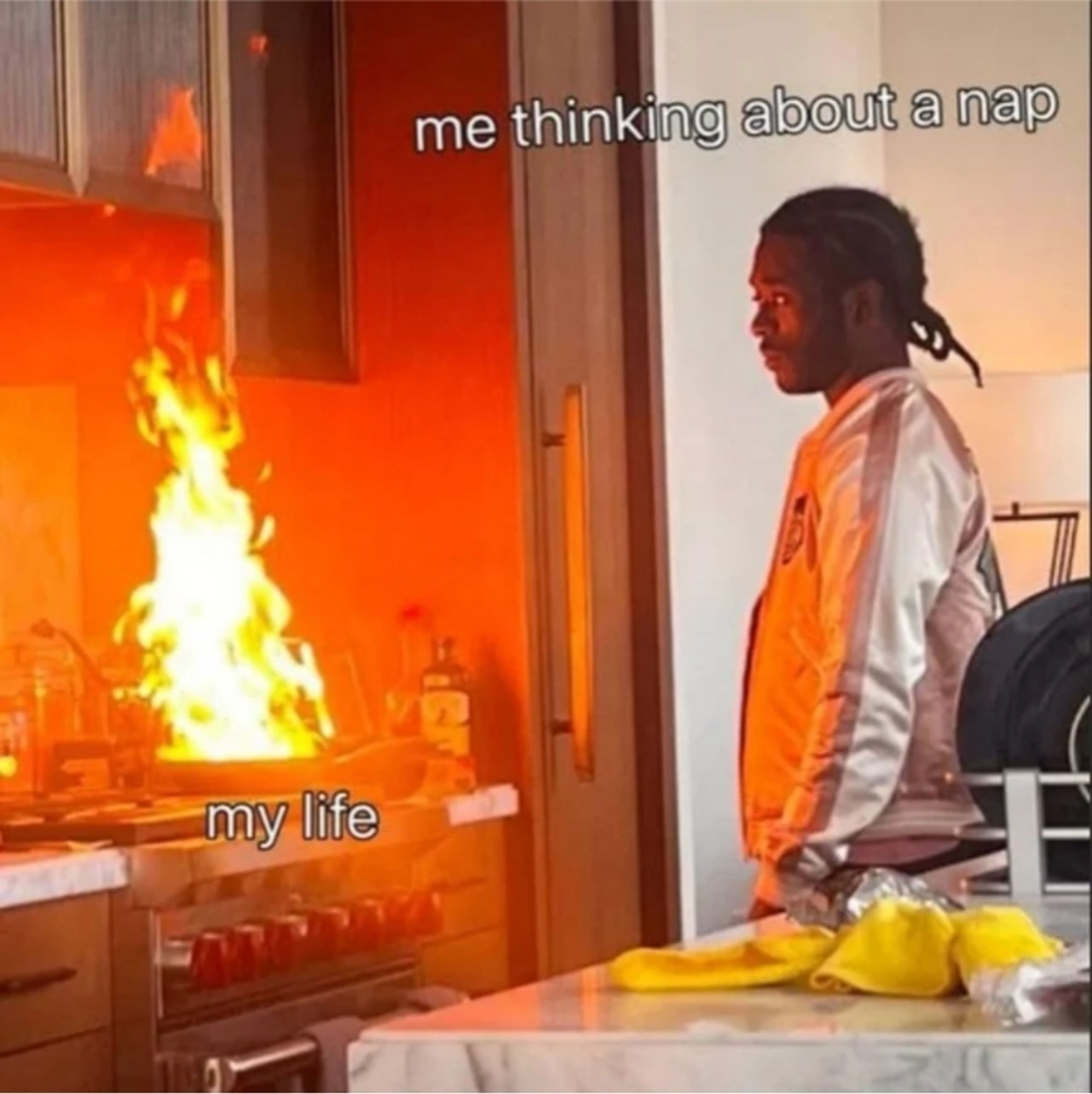 Meme with a photo of Lil Uzi Vert standing in a kitchen watching calmly as a large fire burns in a pan on the stove, with the flames reaching all the way to the cupboards above. Uzi is labelled "me thinking about taking a nap" and the stove is labelled "my life".