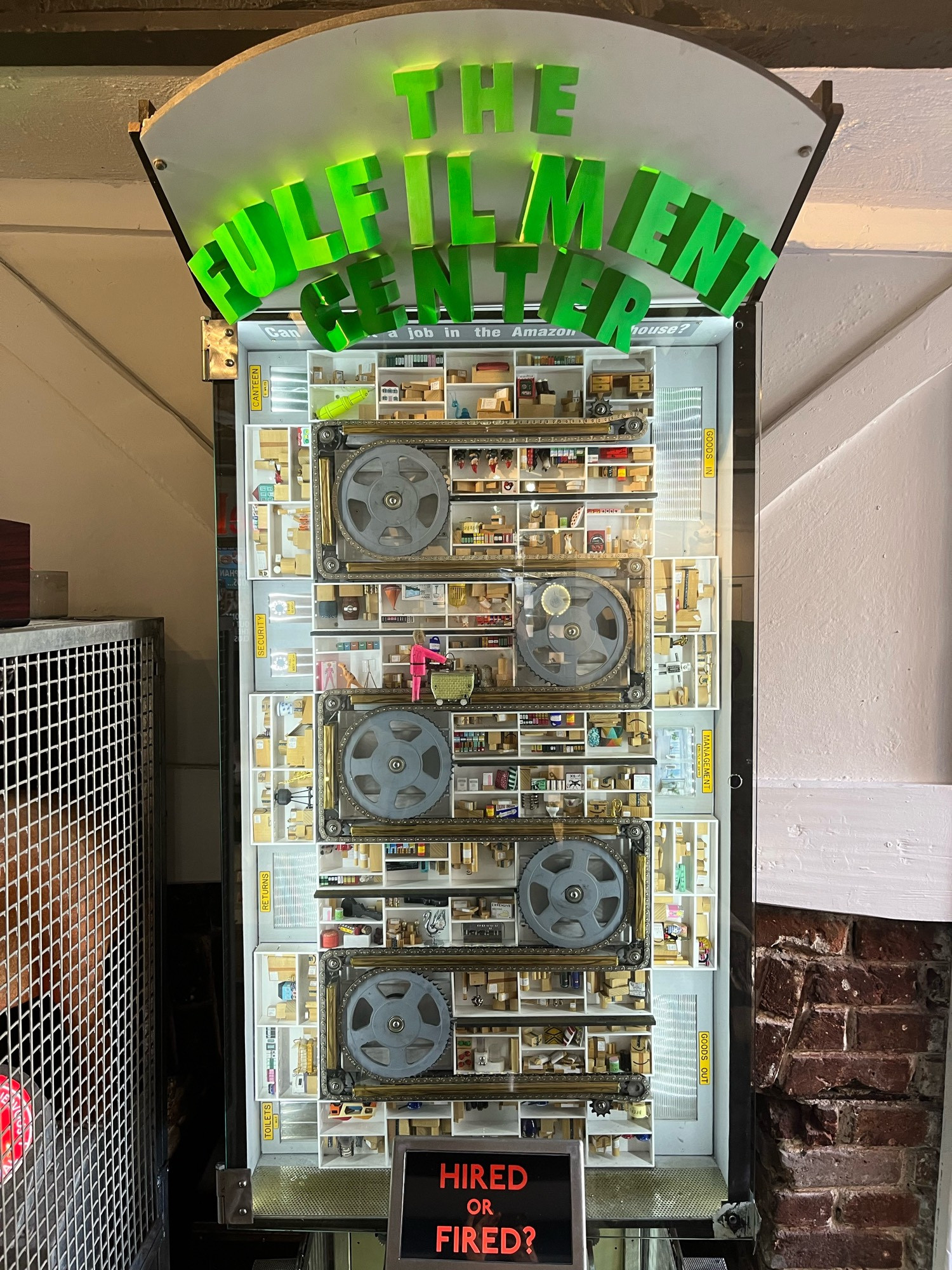 A photo of a handmade arcade machine called The Fulfilment Center. The player has to run on the spot to move a little character around a warehouse in short time limits