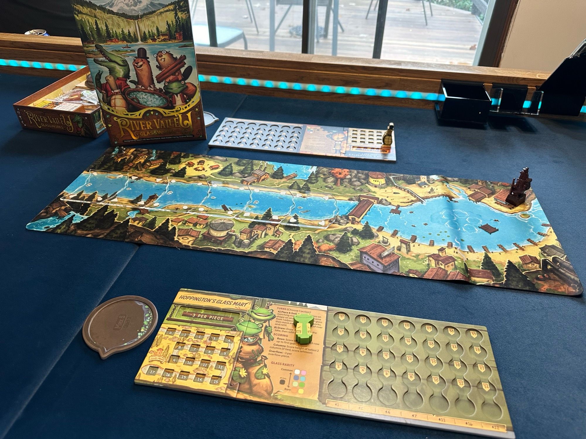 Main board and player board for River Valley Glassworks board game.