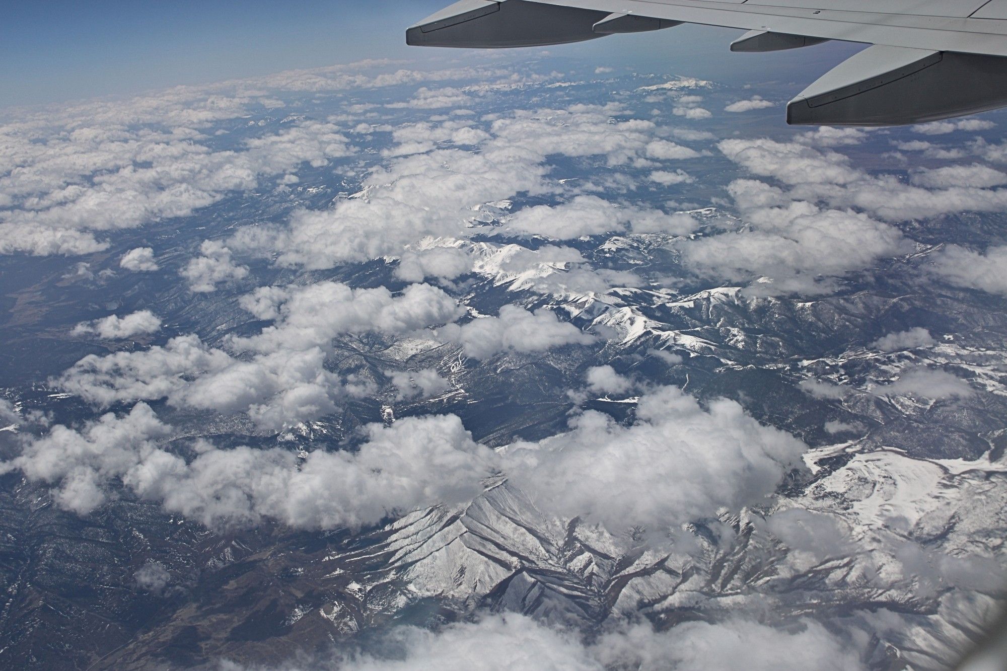 Shot of Rocky Mountains through the window of a plane