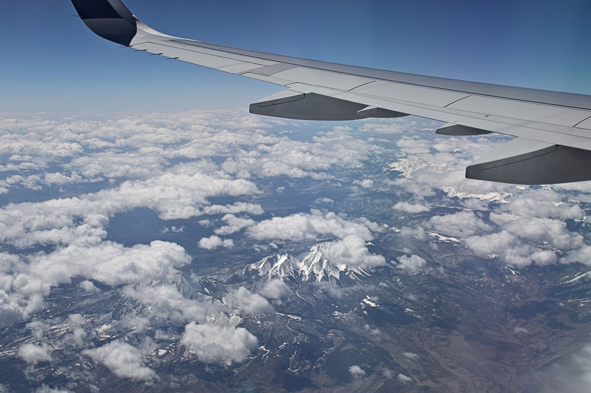 Shot of Rocky Mountains through the window of a plane