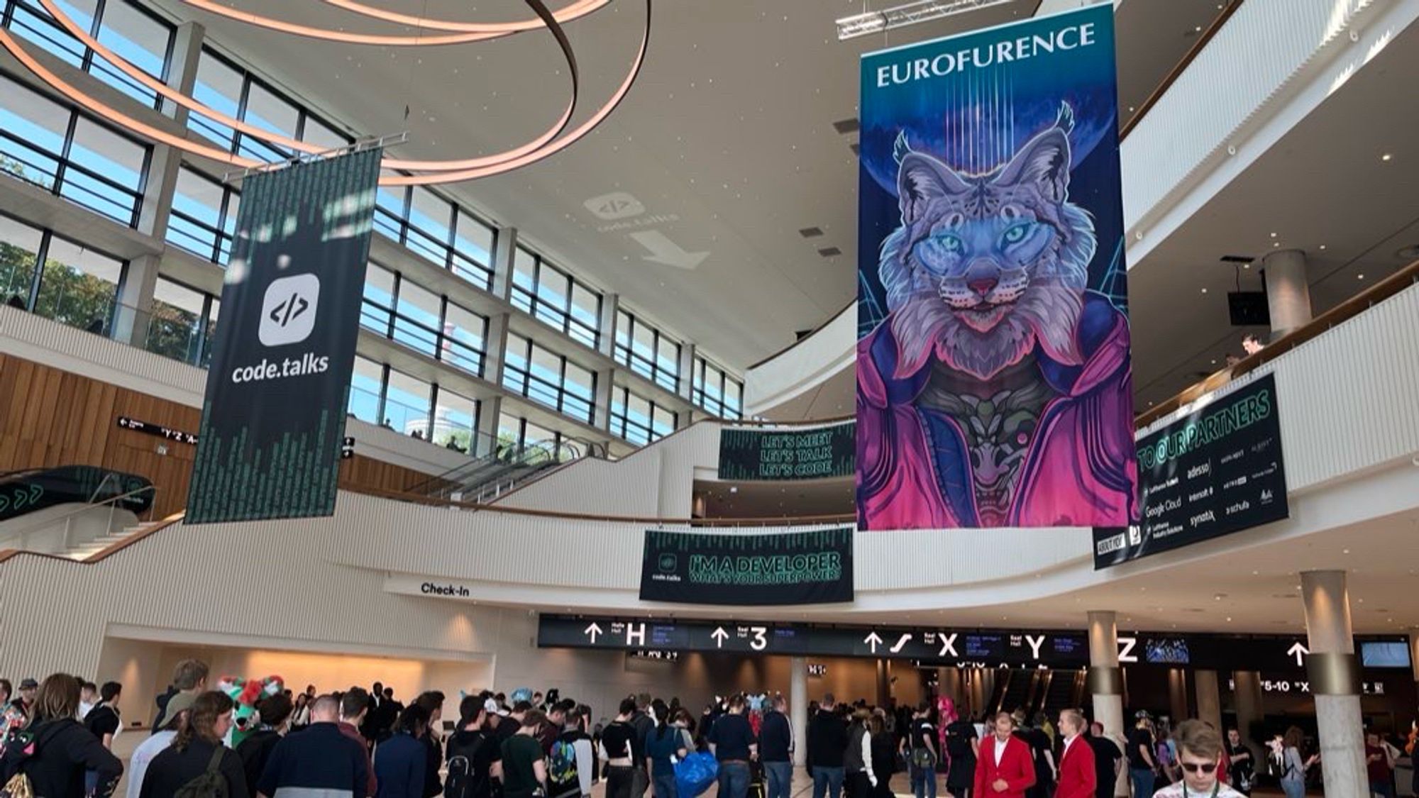 Photograph of entrance of Congress Center Hamburg, showing two banners hanging, one on the left is code.talks, and the one on the right is Eurofurence.