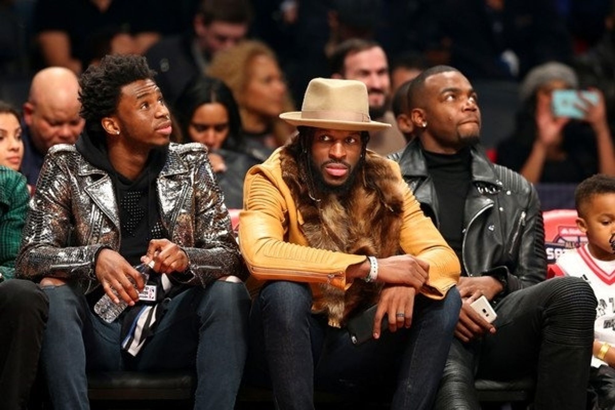 Paul Millsap looks cooler than you would expect (black lesther jcacket over black turtleneck), Wighins is wearing a sweet shiny silver jacket over a black turtleneck and DeMarre Carroll is just the most interesting man alive (mustard yellow leather jacket with fur collar, fancy yet sensible beige hat) in this classic shot from the 2016 ASG Saturday night.