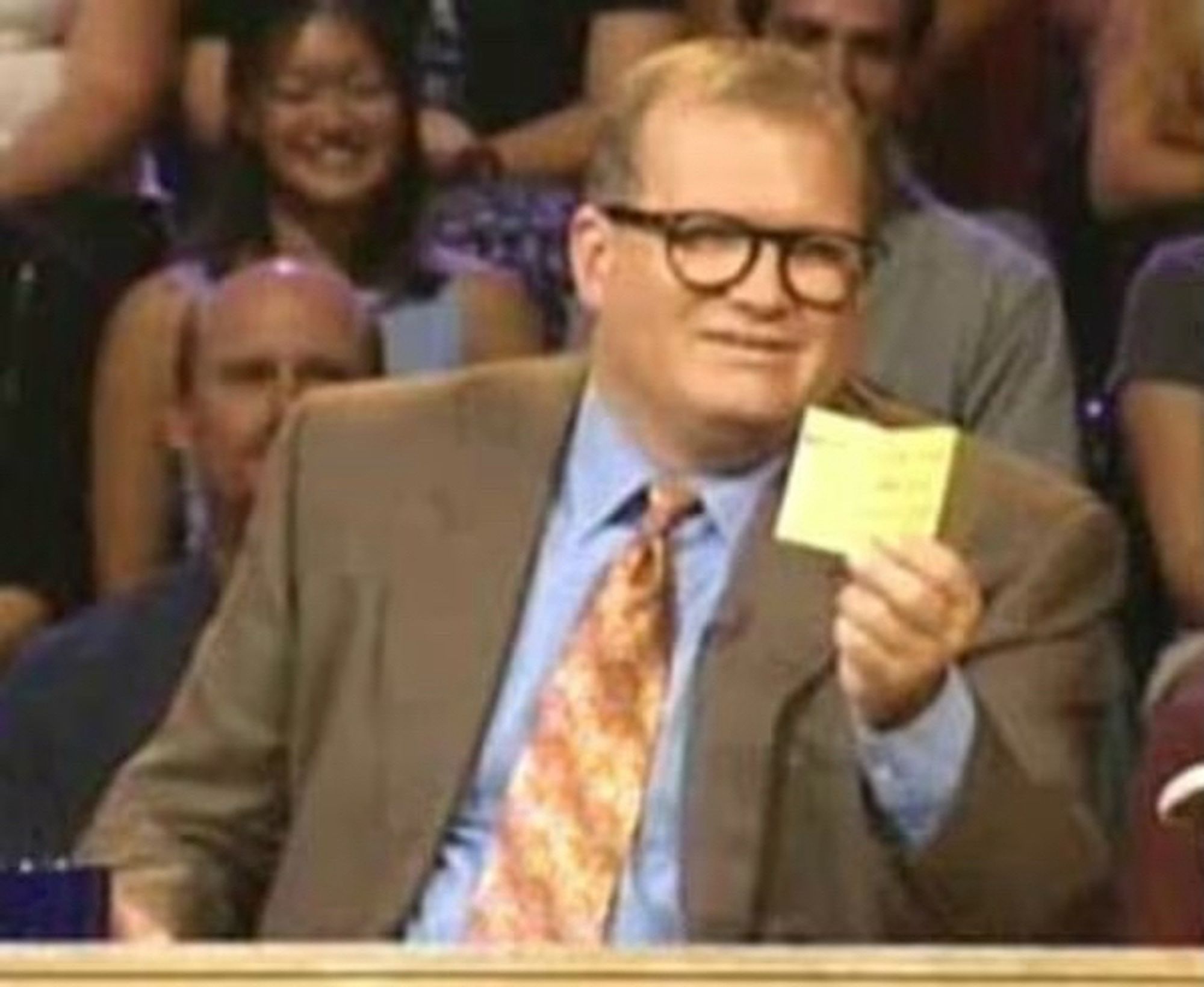 drew carey reading a prompt card on “whose line is it anyway”