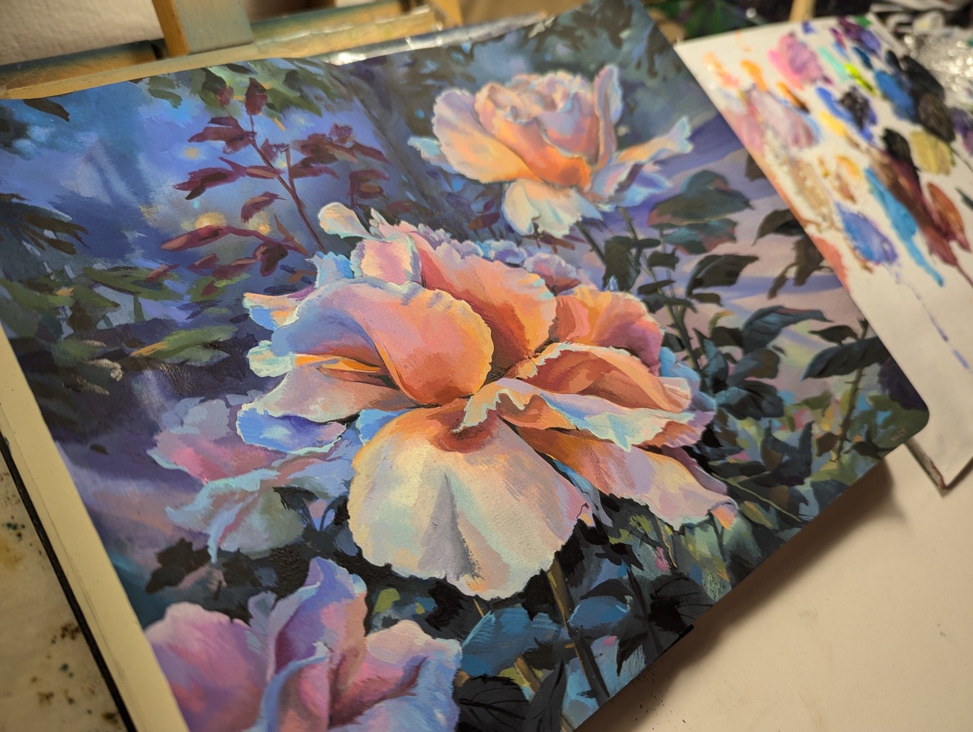 Painting of peach color flowers at night in sketchbook on table