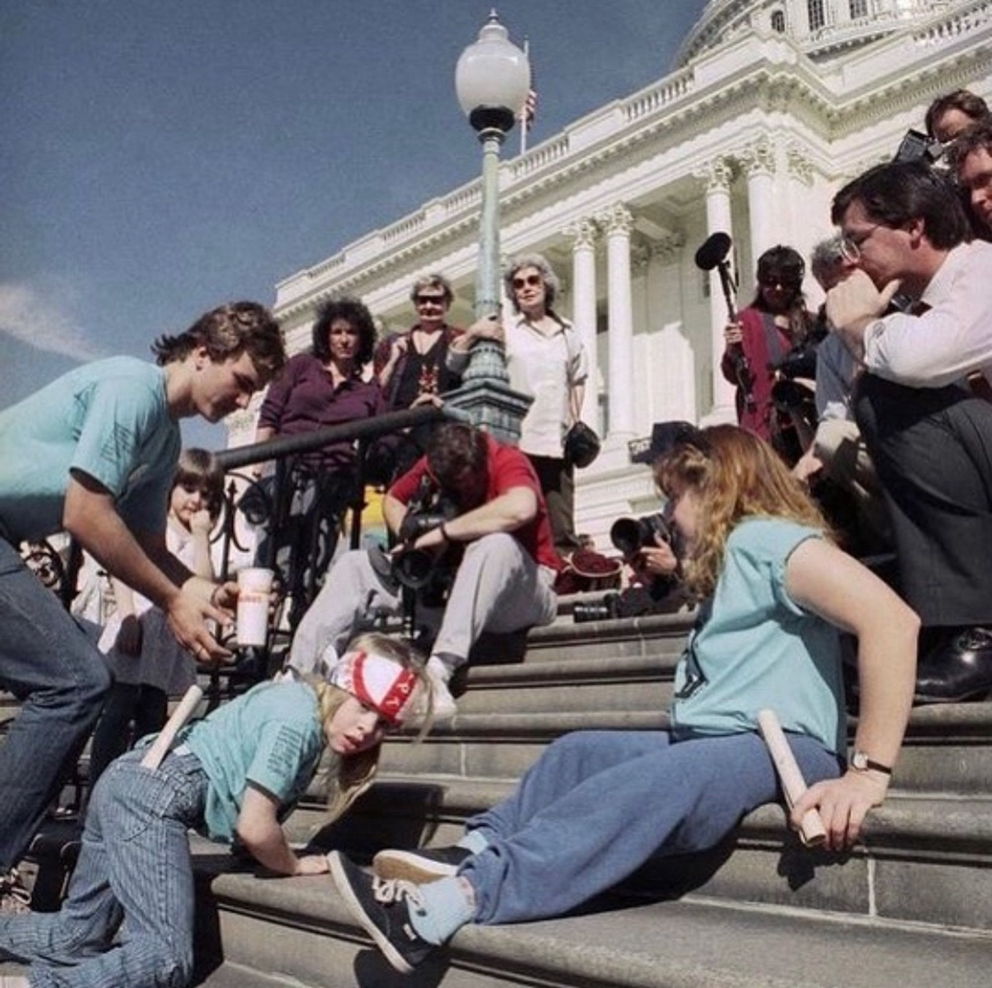 Photo of the historical Capitol Crawl event. On March 12, 1990, over 1,000 people marched from the White House to the U.S. Capitol to demand that Congress pass the Americans with Disabilities Act, or ADA. When they got there, about 60 of them cast aside their wheelchairs and other mobility aids and crawled up the Capitol steps.