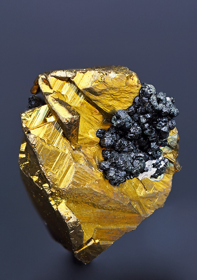 subhedral mass of chalcopyrite adorned with dark subhedral sphalerite crystals