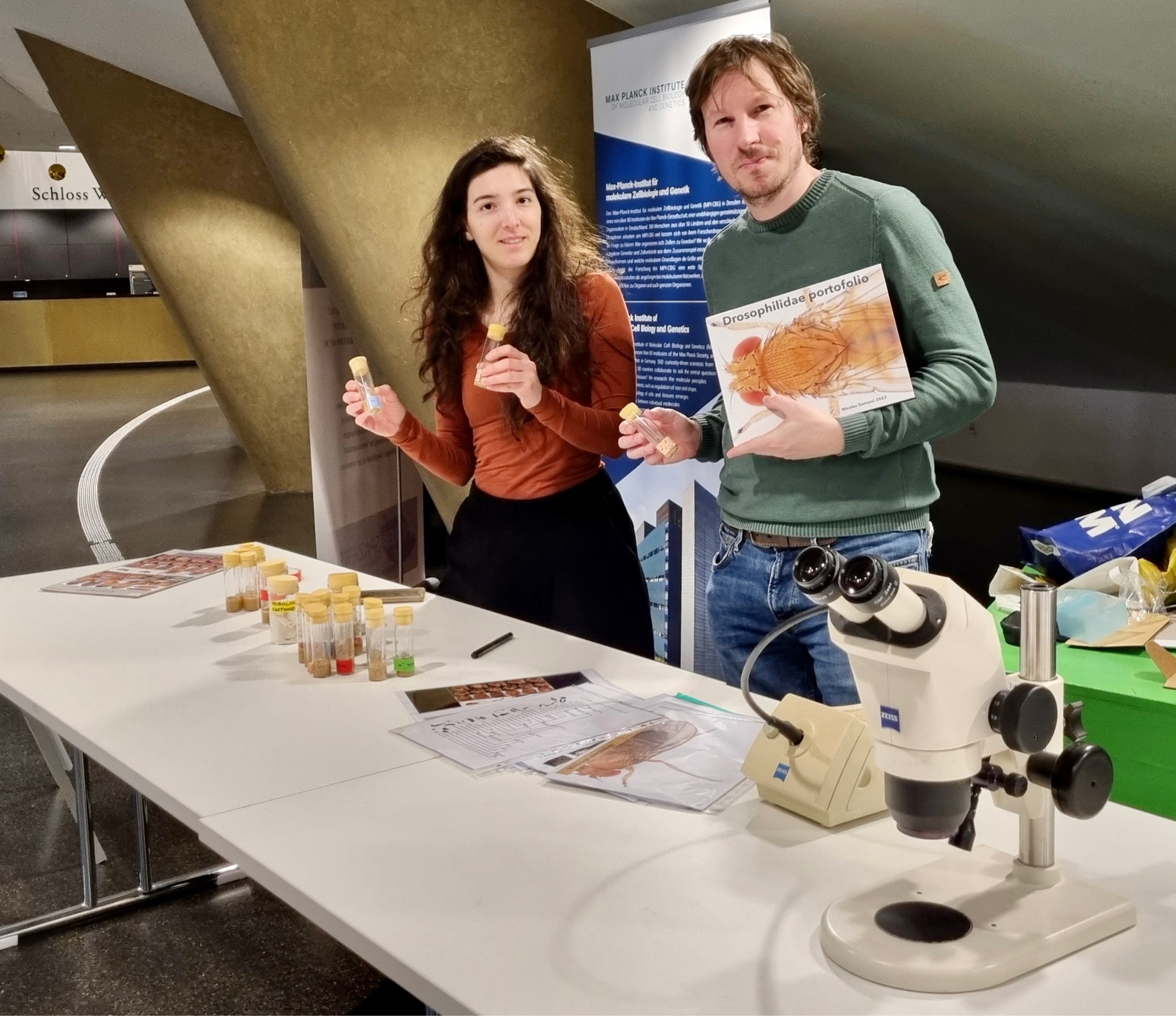 Two researchers at a hands-on science station.