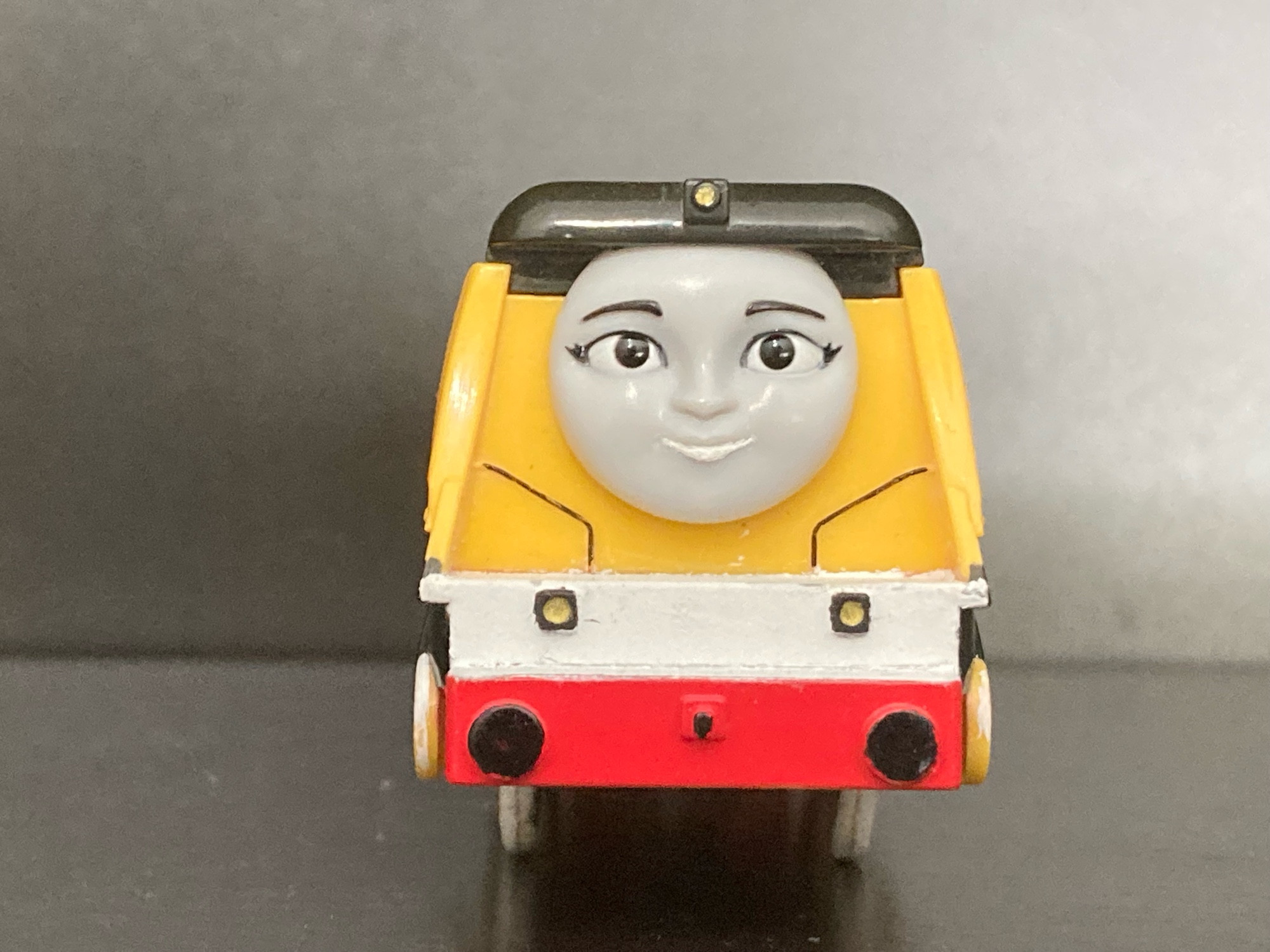 Front view of Rebecca from Thomas and Friends as a Plarail Toy

She is painted yellow with a white footplate, black buffers and lamps, and a red bufferbeam.